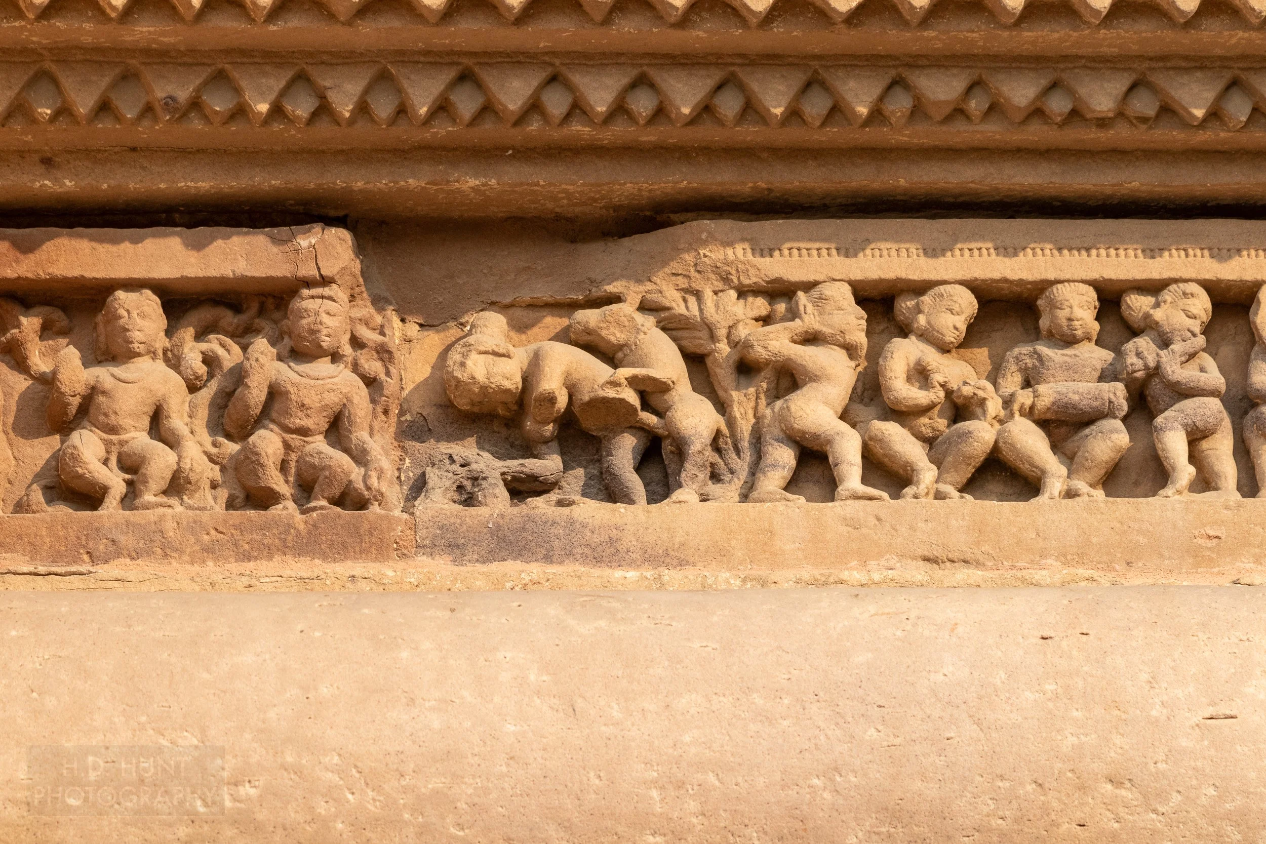 Close-up of the stone carvings adoring the Lakshmana Temple, Khajuraho Group of Monuments, India.