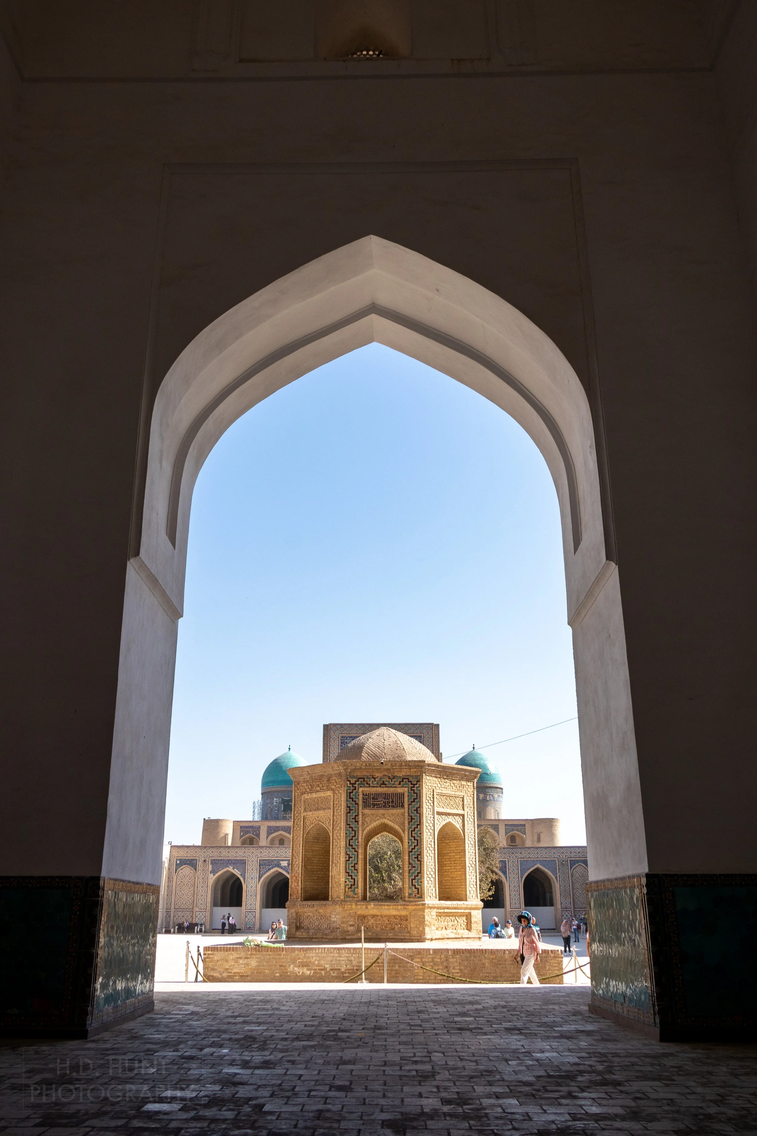 A view of the central courtyard of the Kalan Mosque from inside a large archway, Bukhara, Uzbekistan.