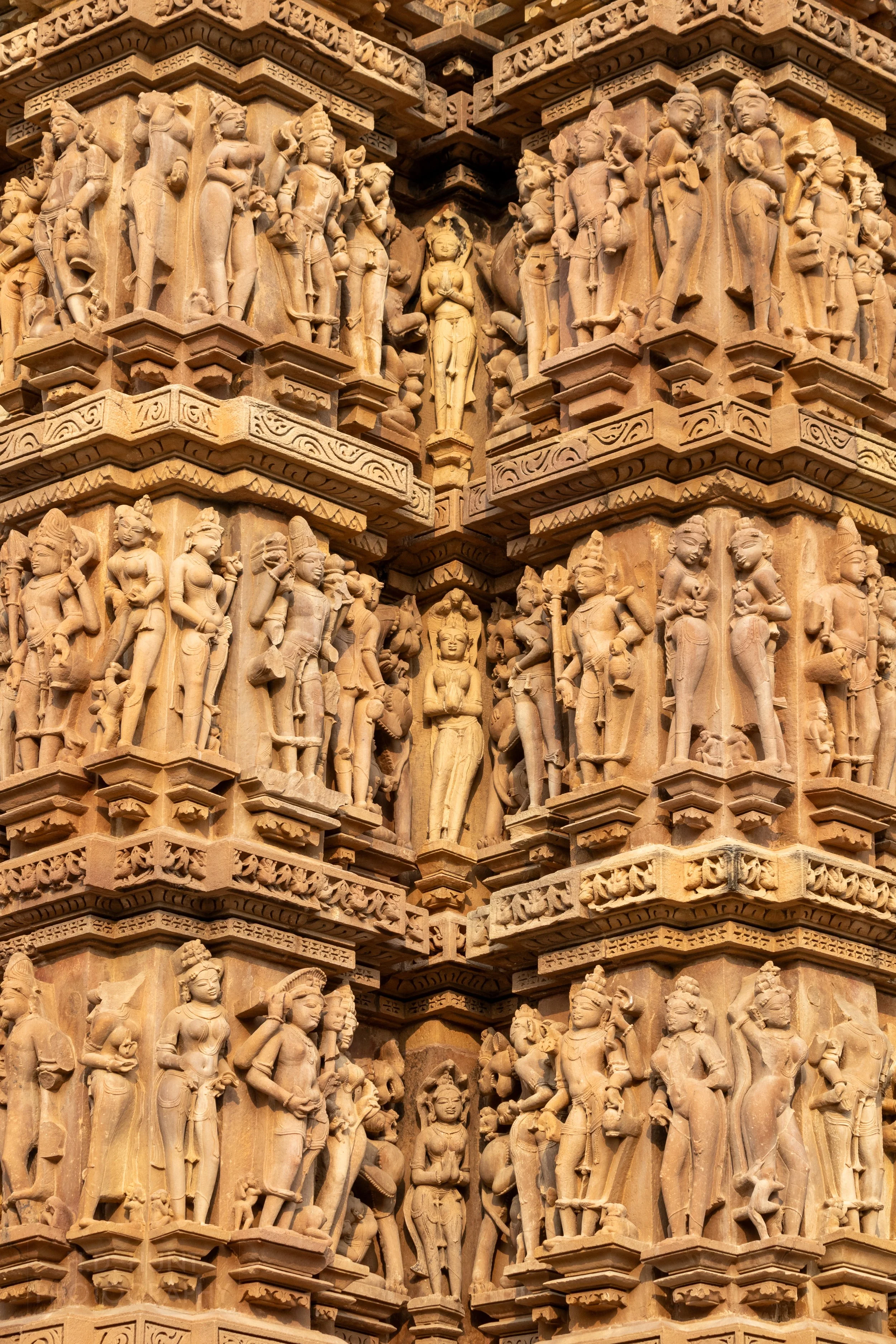 Close-up of the stone carvings adoring Kandariya Mahadeva, Khajuraho Group of Monuments, India.