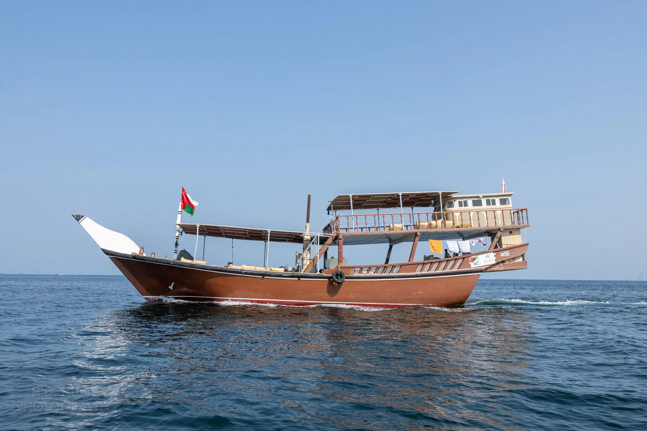 A dhow boat sits in the Strait of Hormuz near the Musandam Peninsula, Oman.