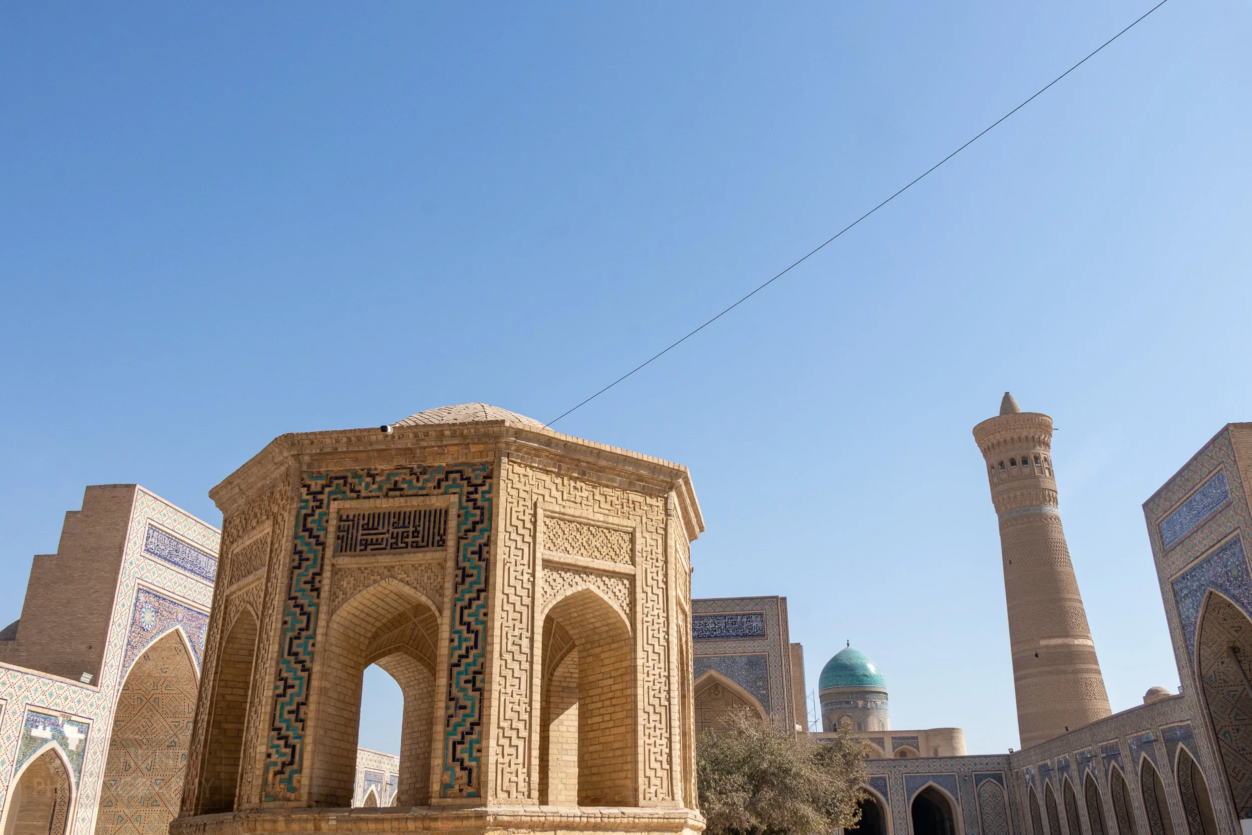 A view across the central courtyard of the Kalan Mosque to the Kalan Minaret, Bukhara, Uzbekistan.