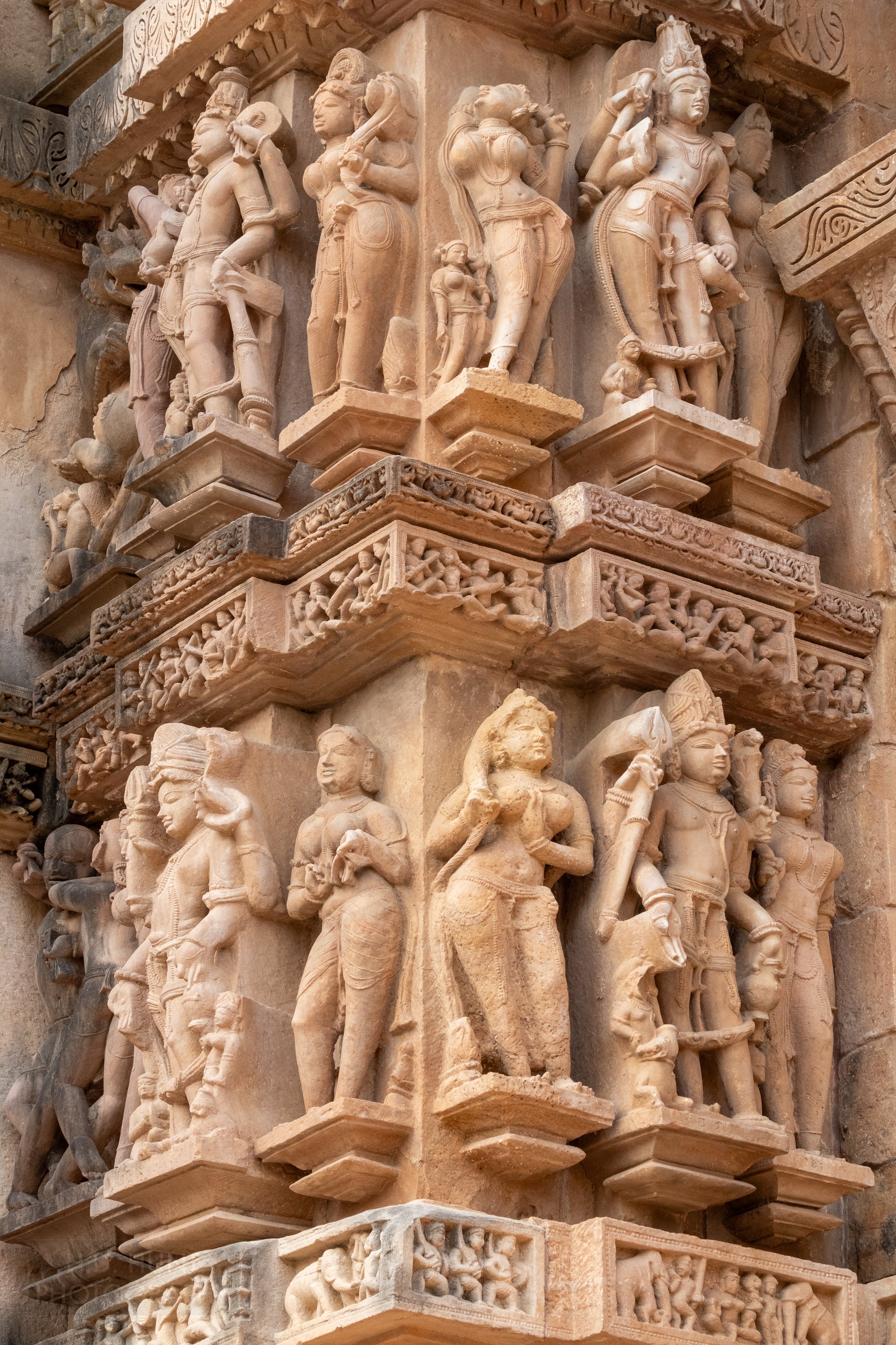 Close-up of the stone carvings adoring the Lakshmana Temple, Khajuraho Group of Monuments, India.