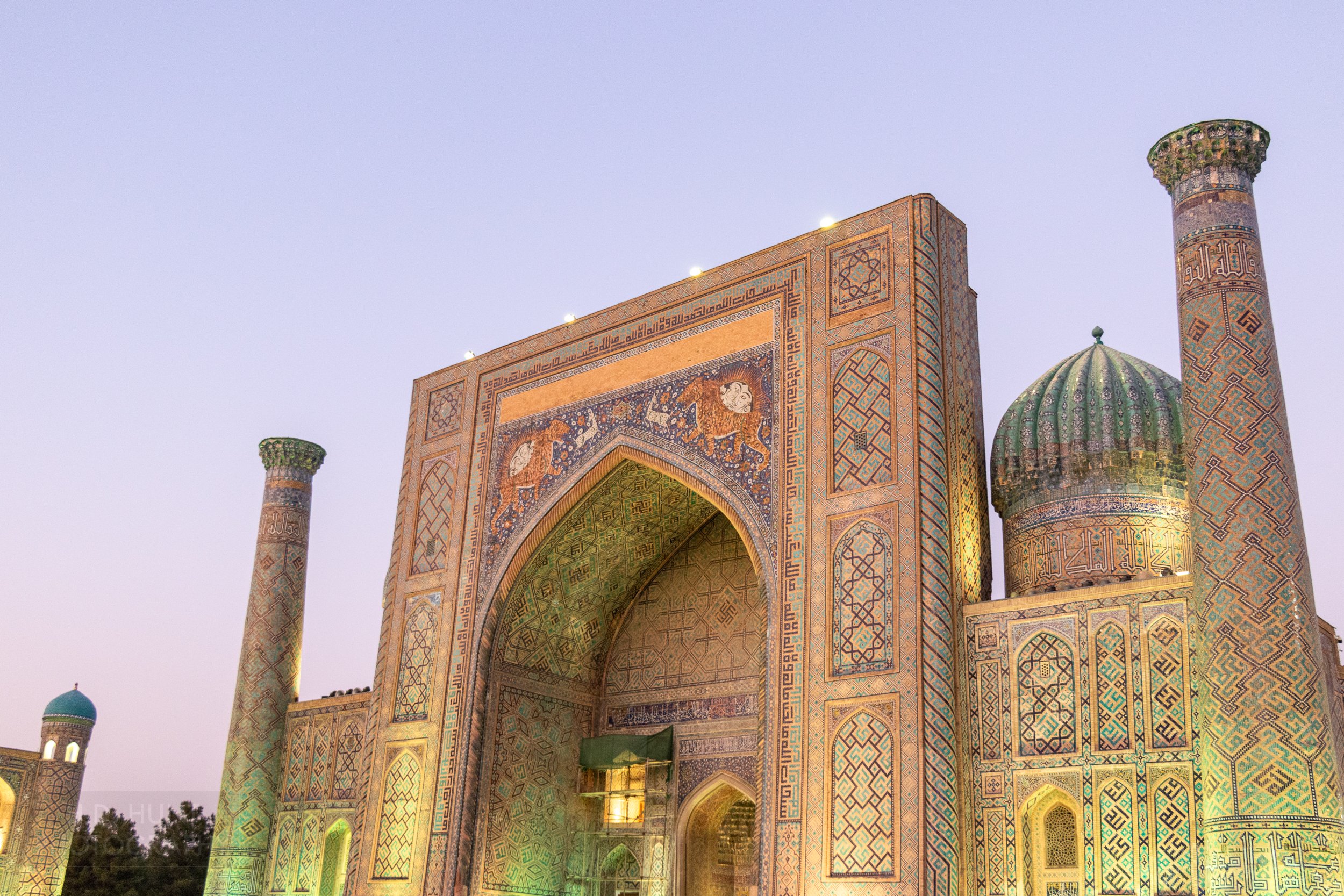 Exterior of the Sher-Dor Madrasa at sunset at the Registan in Samarkand, Uzbekistan.
