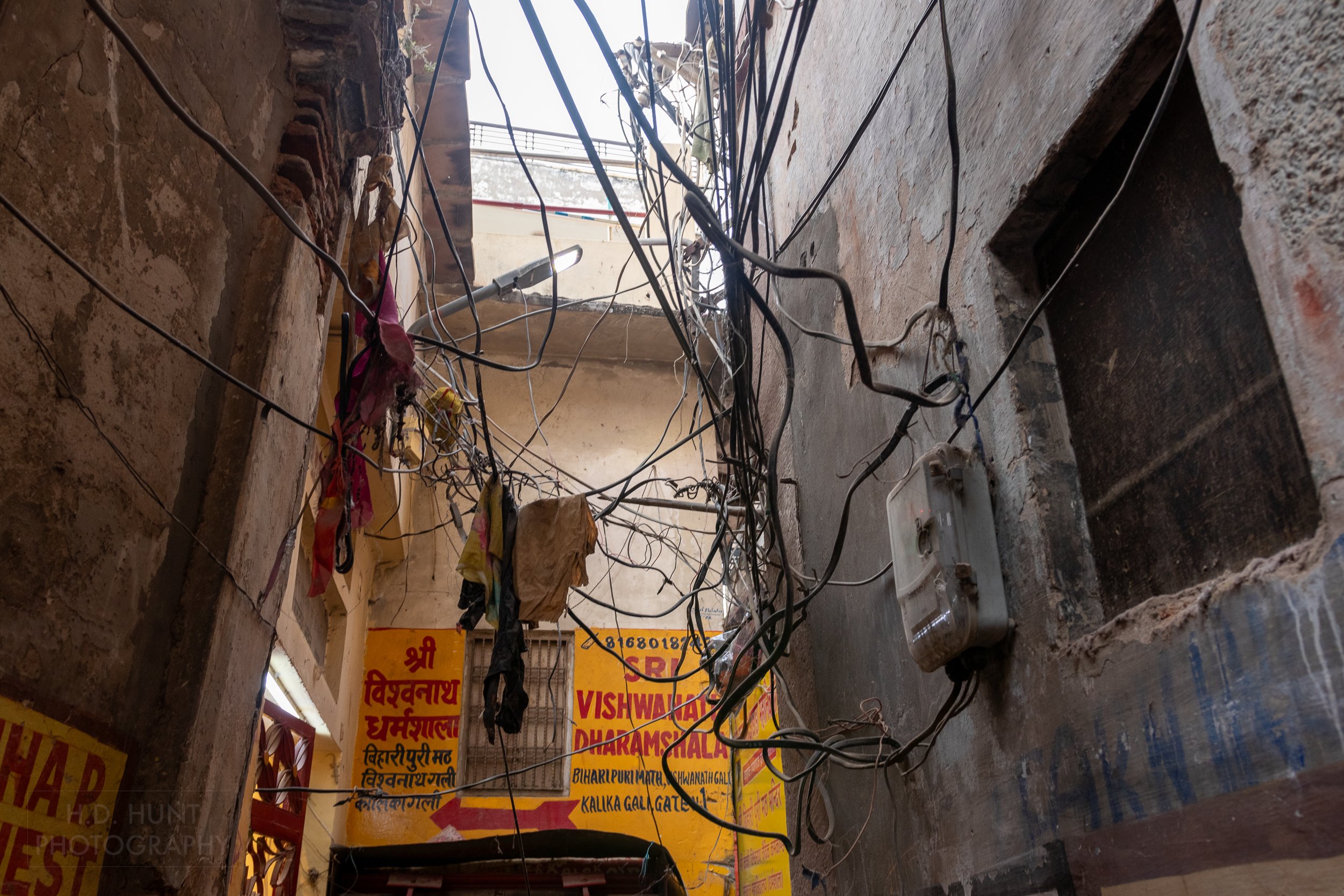 A jumble of electrical wires in an alleyway, Varanasi, India.