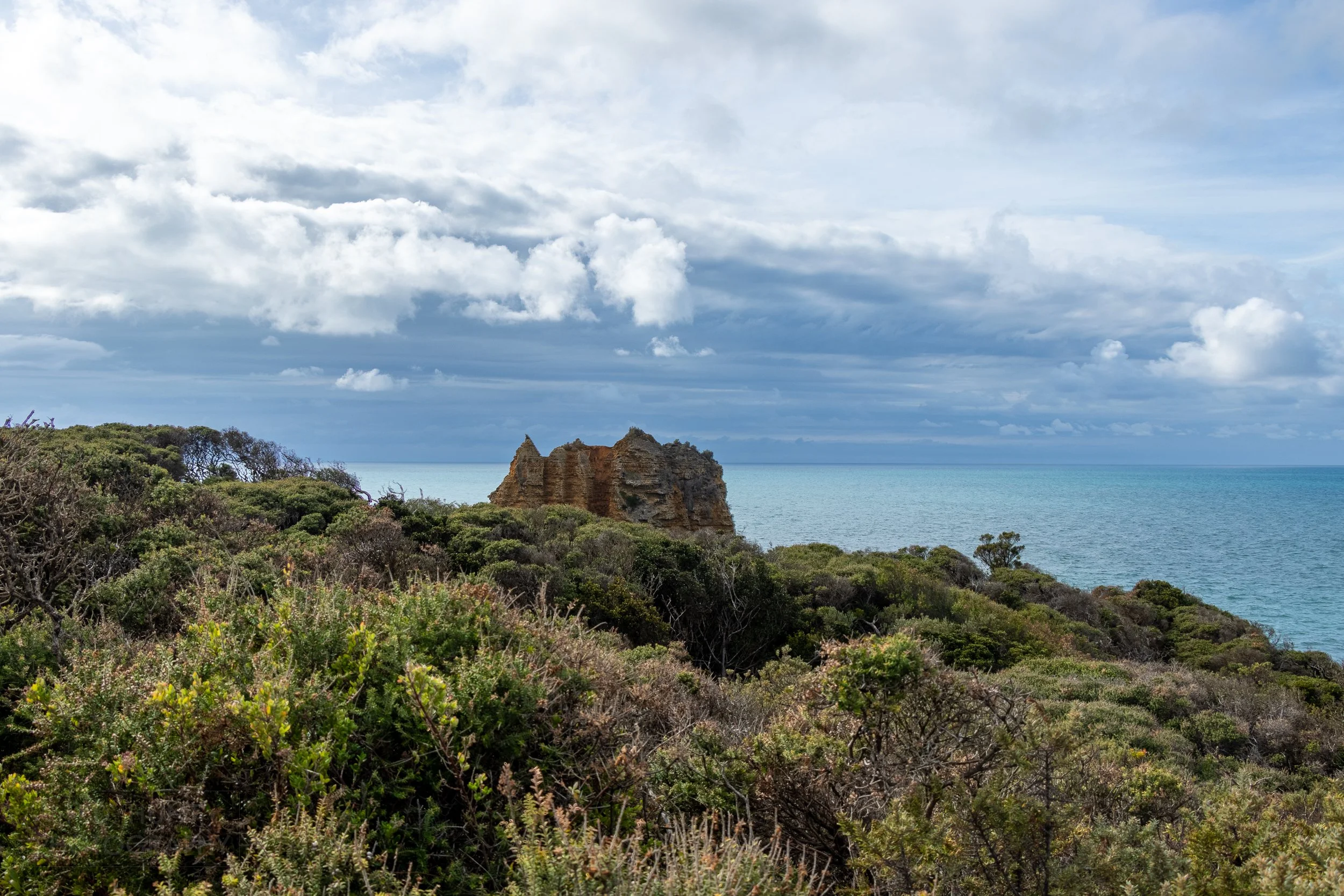 Eagle Rock rises above the tree line near Spit Point, Aireys Inlet, Victoria, Australia.