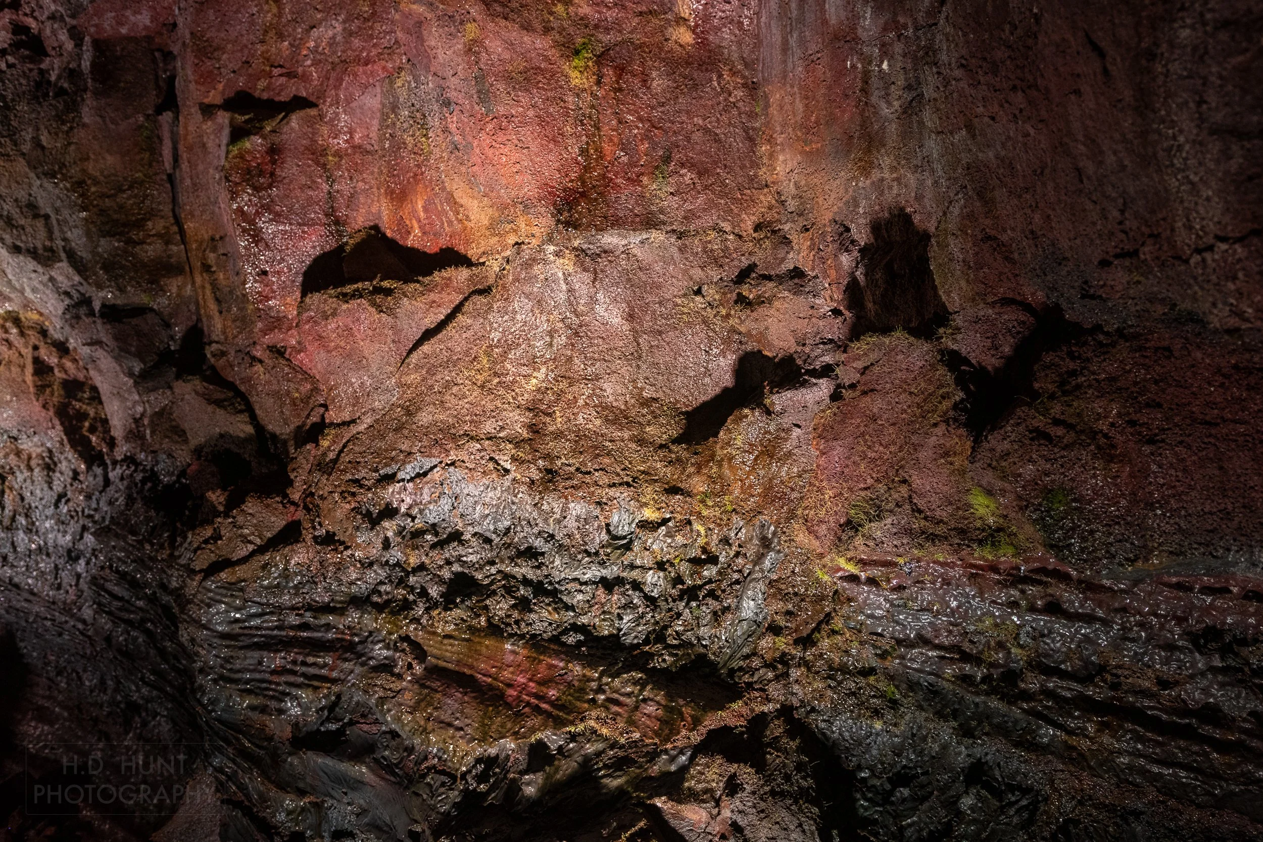 Multi-colored, highly-textured walls within the lava tube Raufarhólshellir, Iceland.