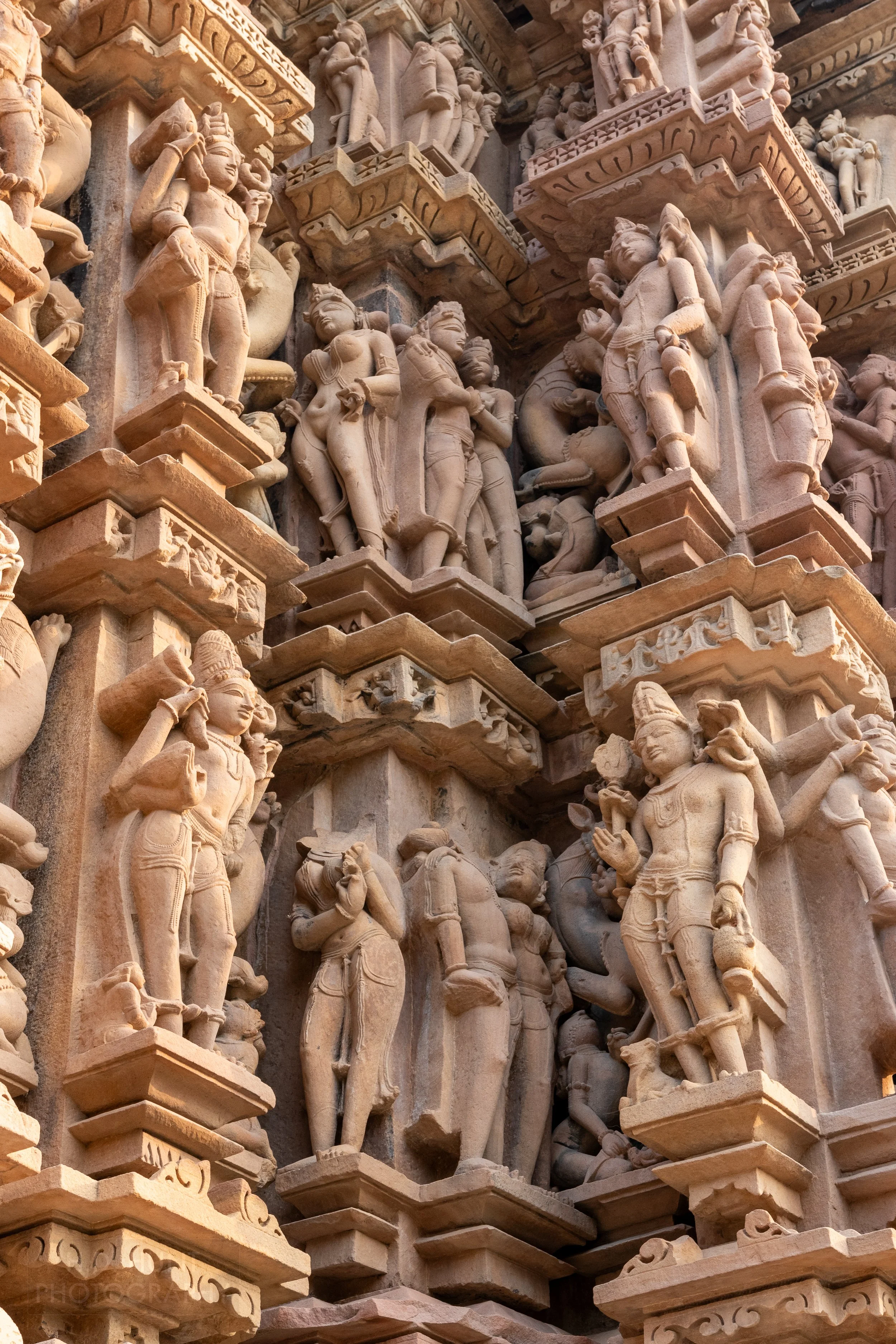Close-up of the stone carvings adoring Devi Jagadambi Temple, Khajuraho Group of Monuments, India.