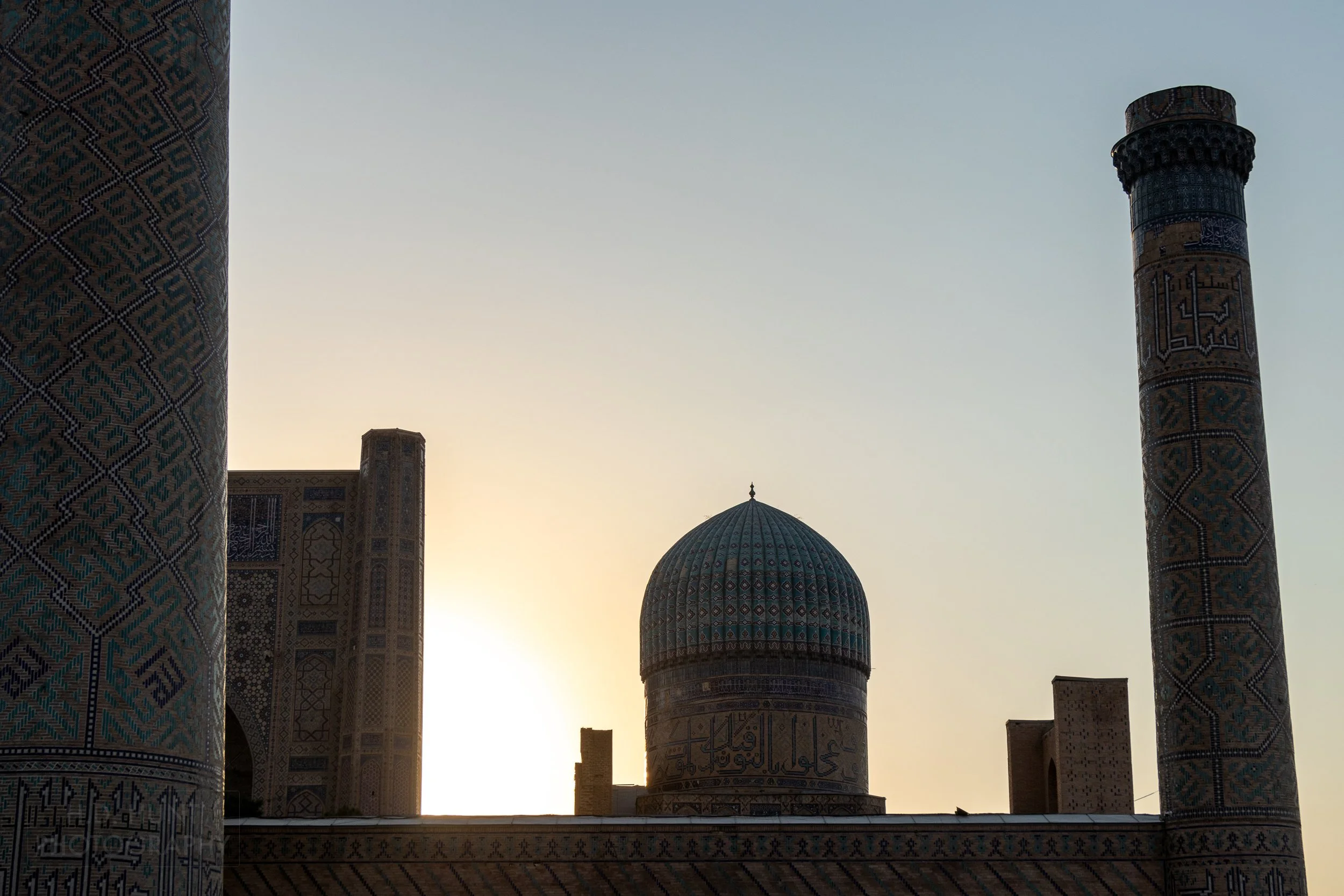 The sun sets behind the Bibi-Khanym Mosque, Samarkand, Uzbekistan.