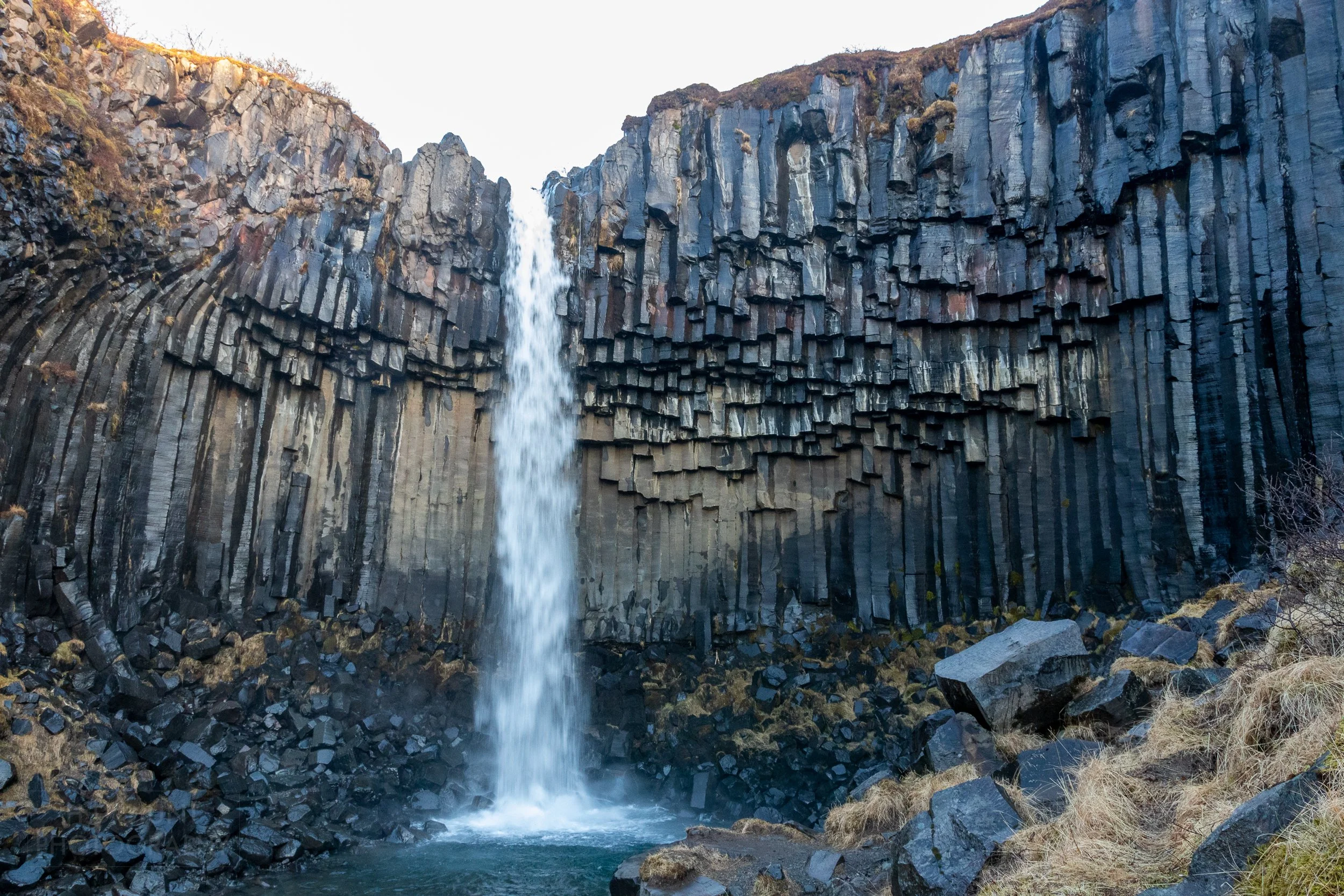 The waters of Svartifoss cascade over black basalt columns, Iceland.