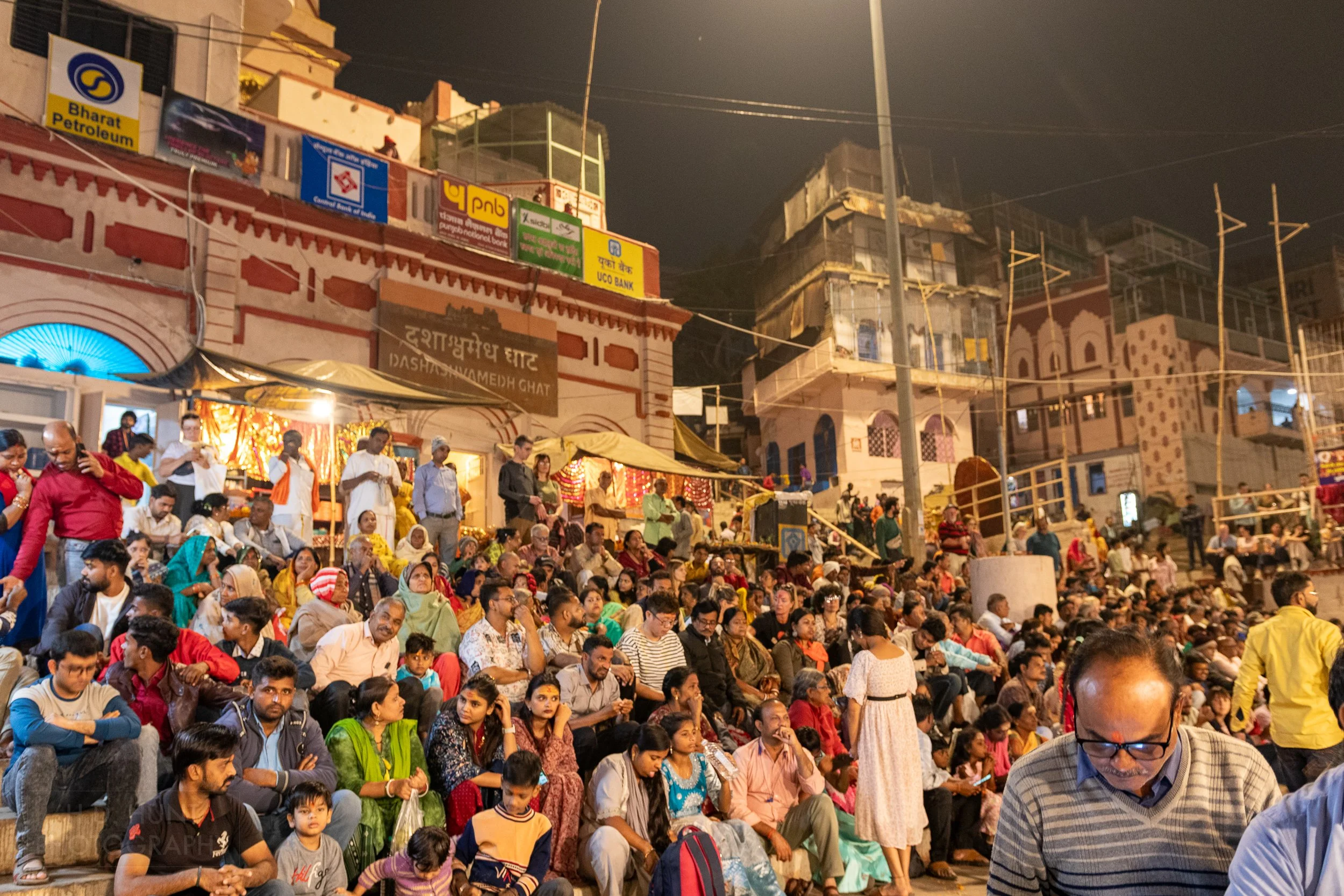 A crowd gathers to watch a religious ceremony, Varanasi, India.