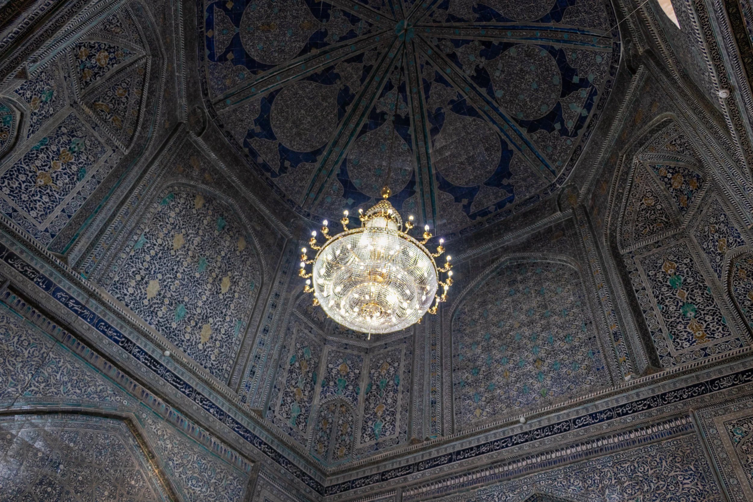 An elegant chandelier hangs from the ceiling of the Pahlavan Mahmoud Mausoleum in Khiva, Uzbekistan.