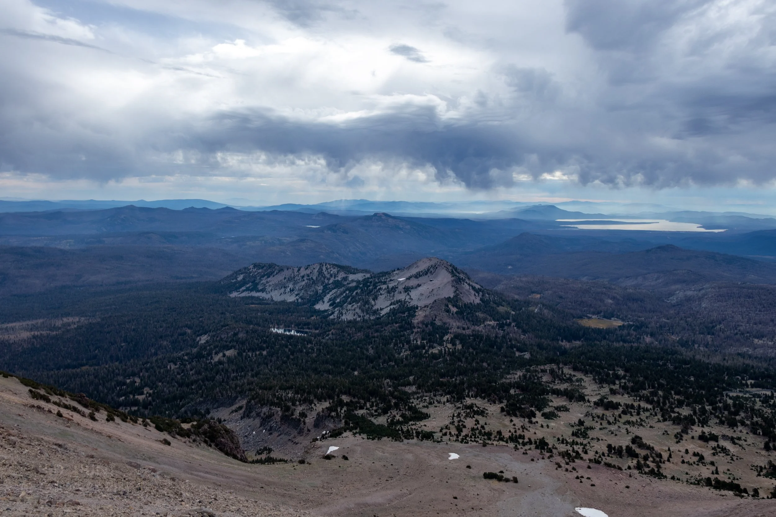 Clouds darken the landscape looking outwards from Lassen Peak, Lassen Volcanic National Park, California, United States.