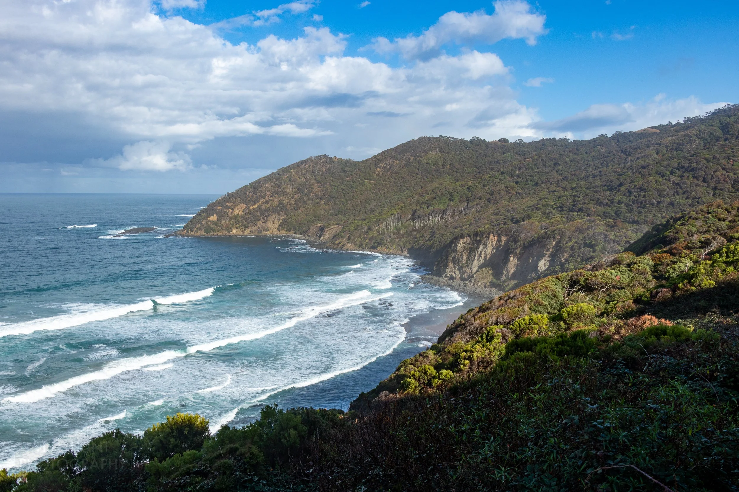 The sea crashes into tall cliffs along The Great Ocean Walk, Victoria, Australia.