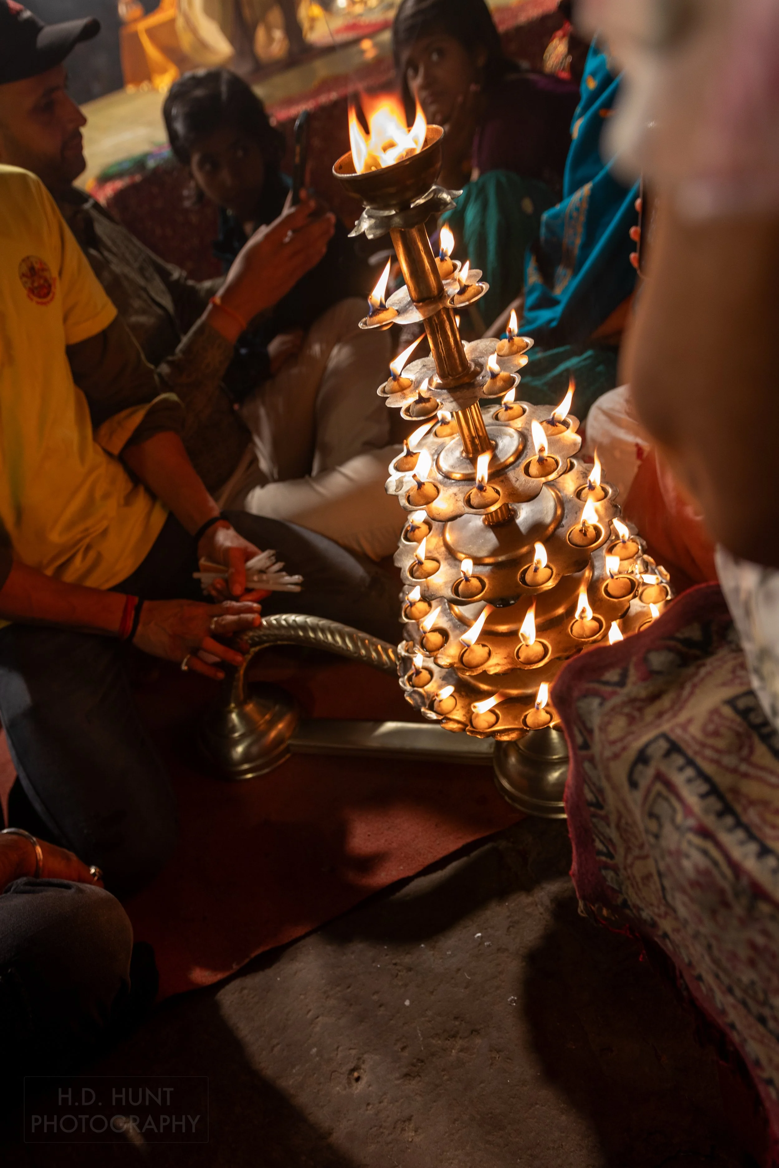 A crowd lights candles during a Hindu religious ceremony called arti, Varanasi, India.