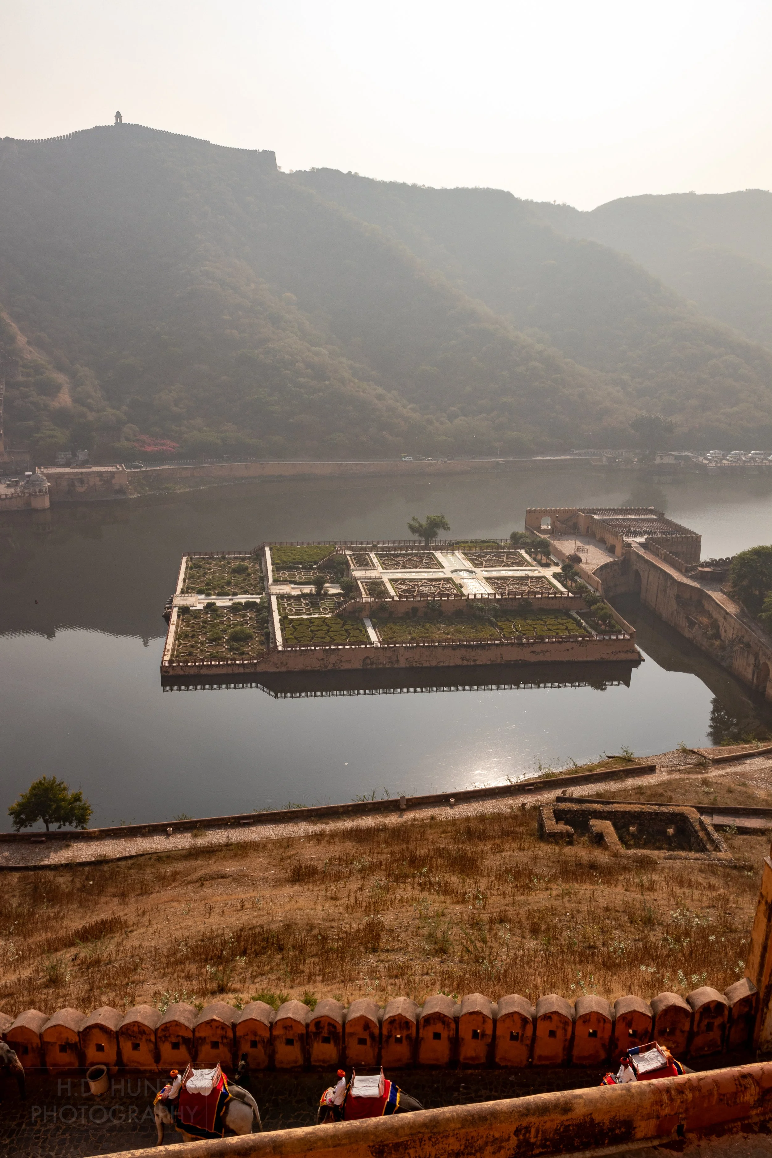 An island with manicured gardens is seen within a small lake near Amber Fort, Amer, India.