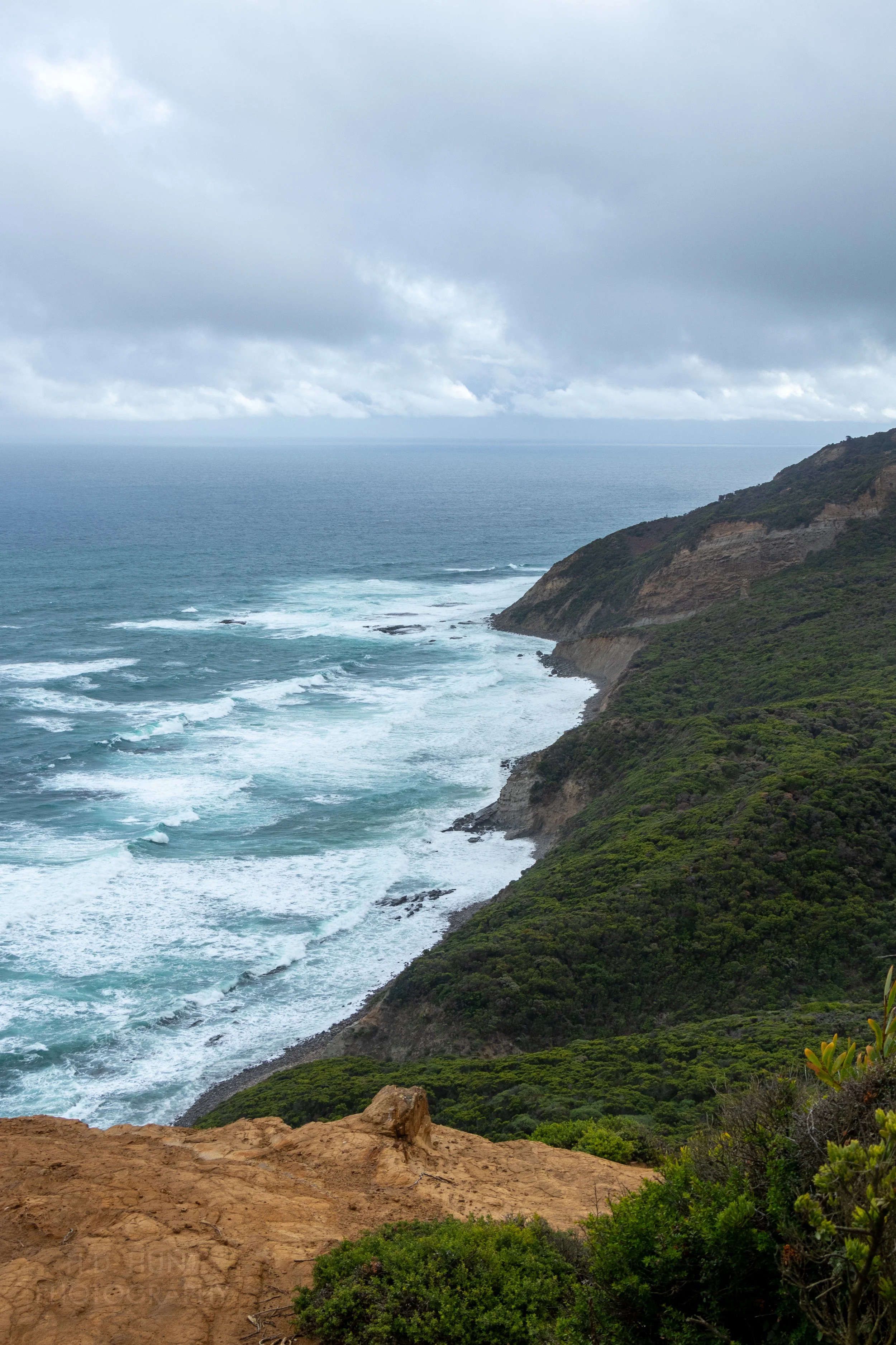 The ocean crashes against tall cliffs along The Great Ocean Walk, Victoria, Australia.