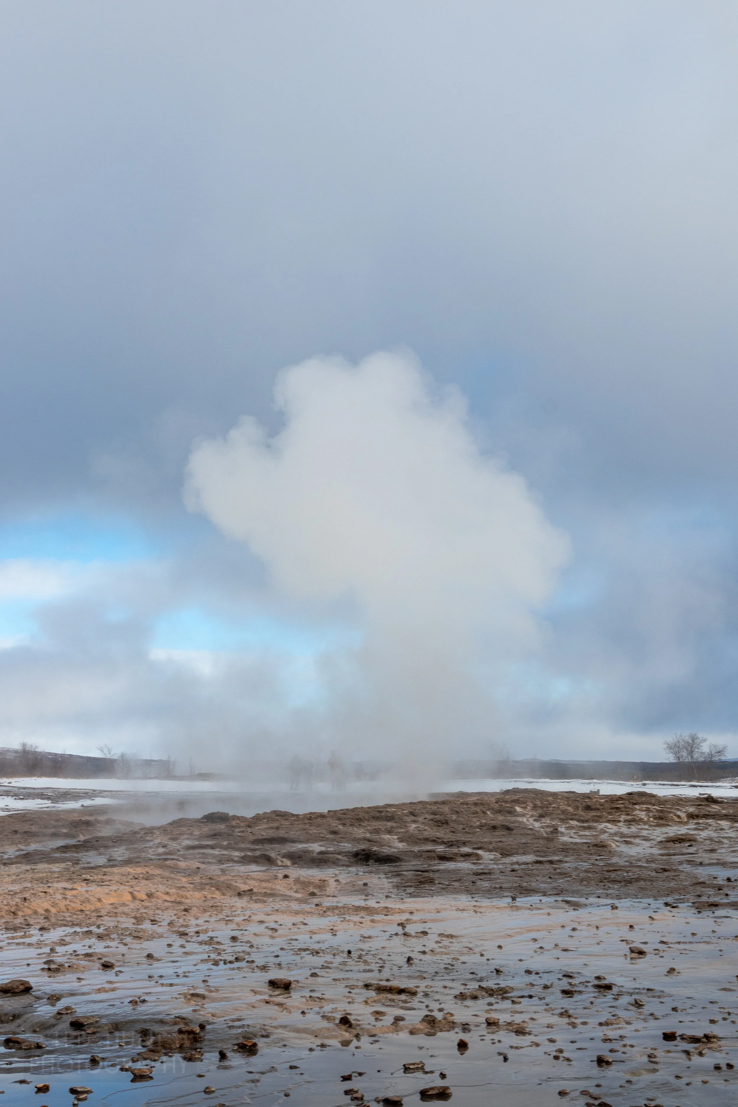 A column of steam rises from the Strokkur geyser at Haukadalur, Iceland.