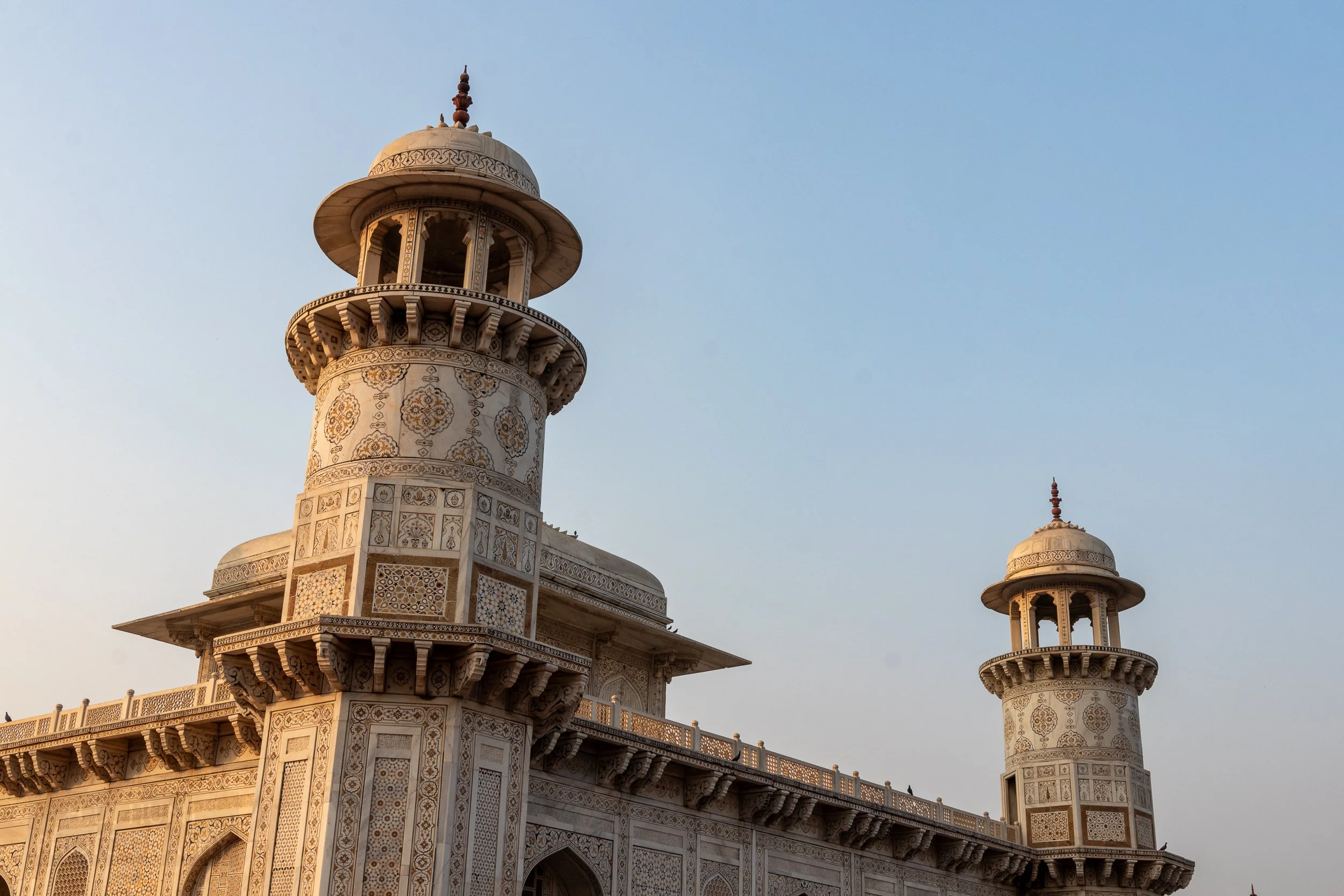 Two white stone towers of the Tomb of I’timad-ud-Daulah, Agra, India.