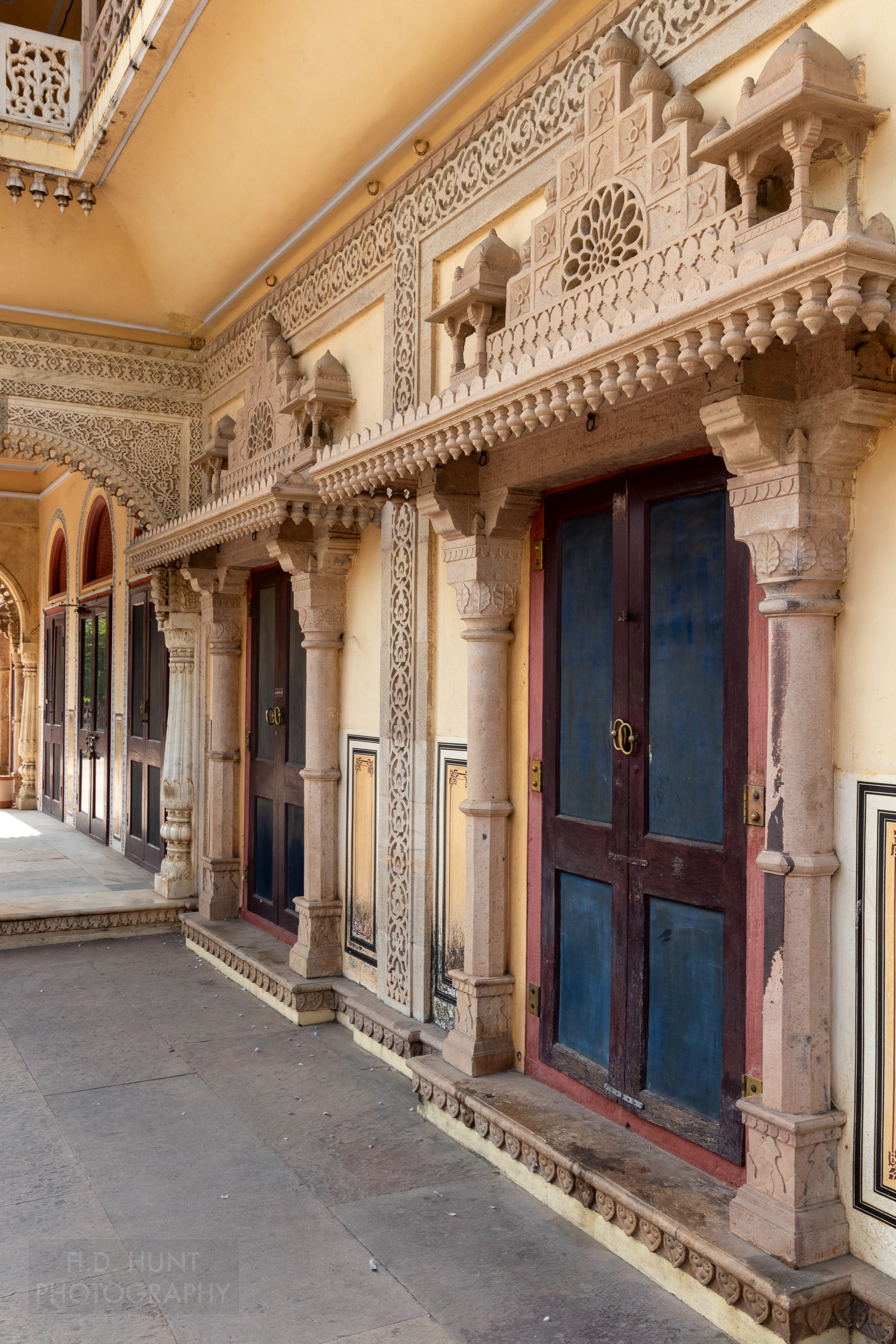 Several doors with intricately carved stone doorways, City Palace, Jaipur, India.