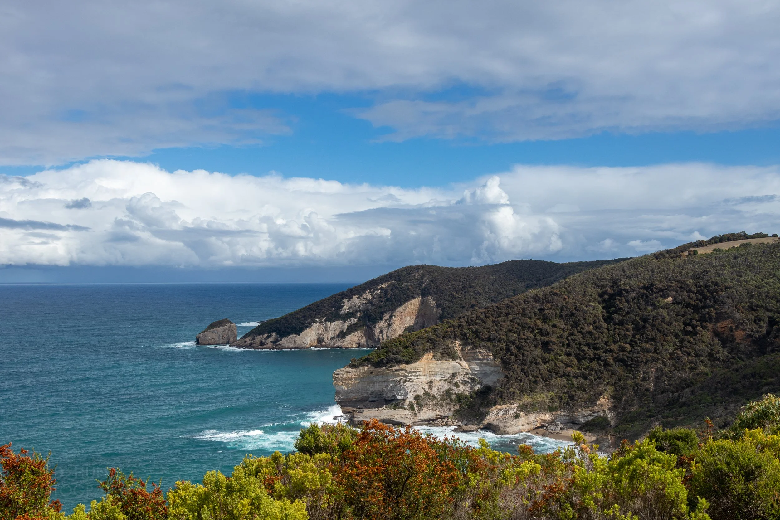 The ocean lashes against white chalk cliffs along The Great Ocean Walk, Victoria, Australia.