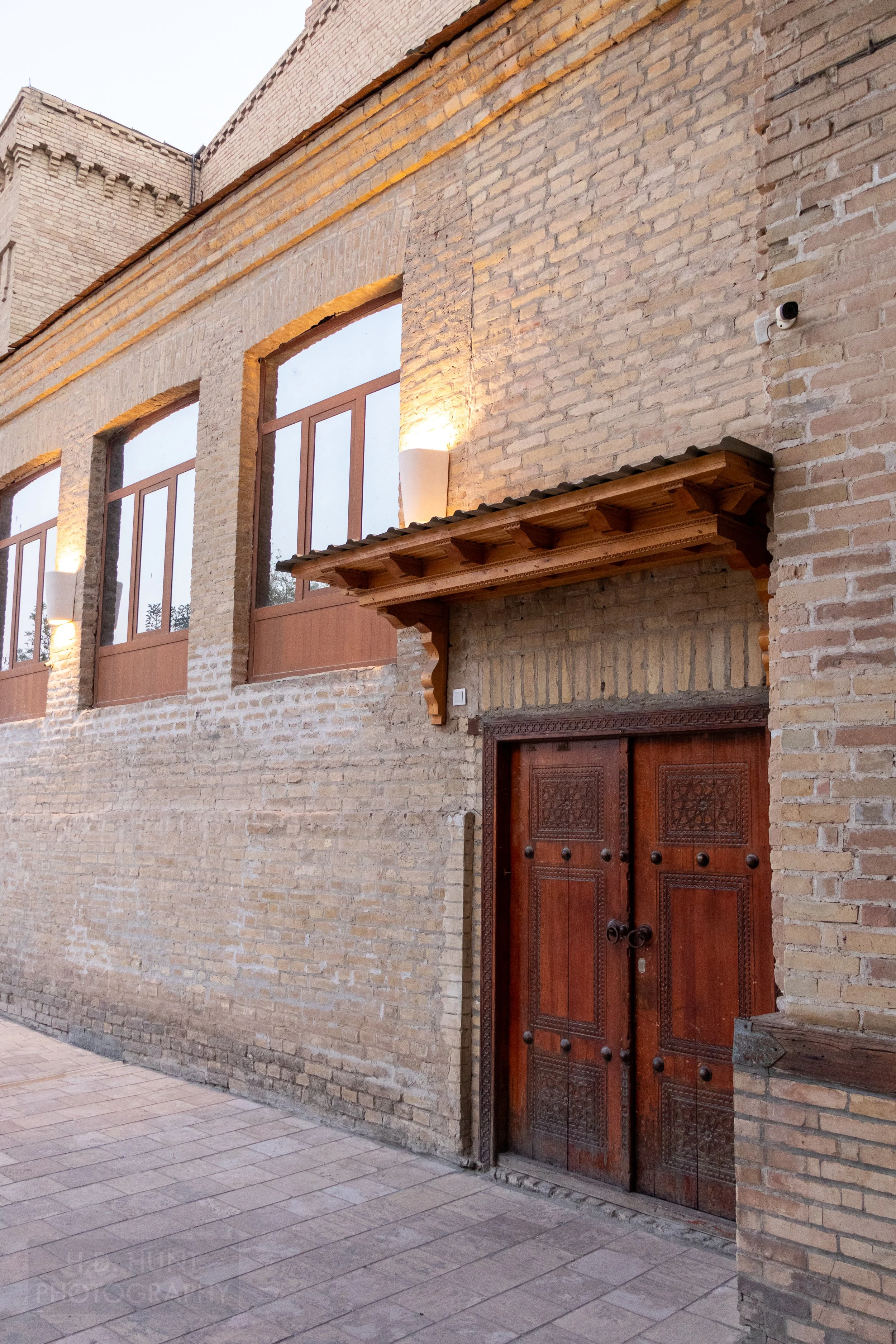 A wooden double door in a pristine stone alleyway, Bukhara, Uzbekistan.
