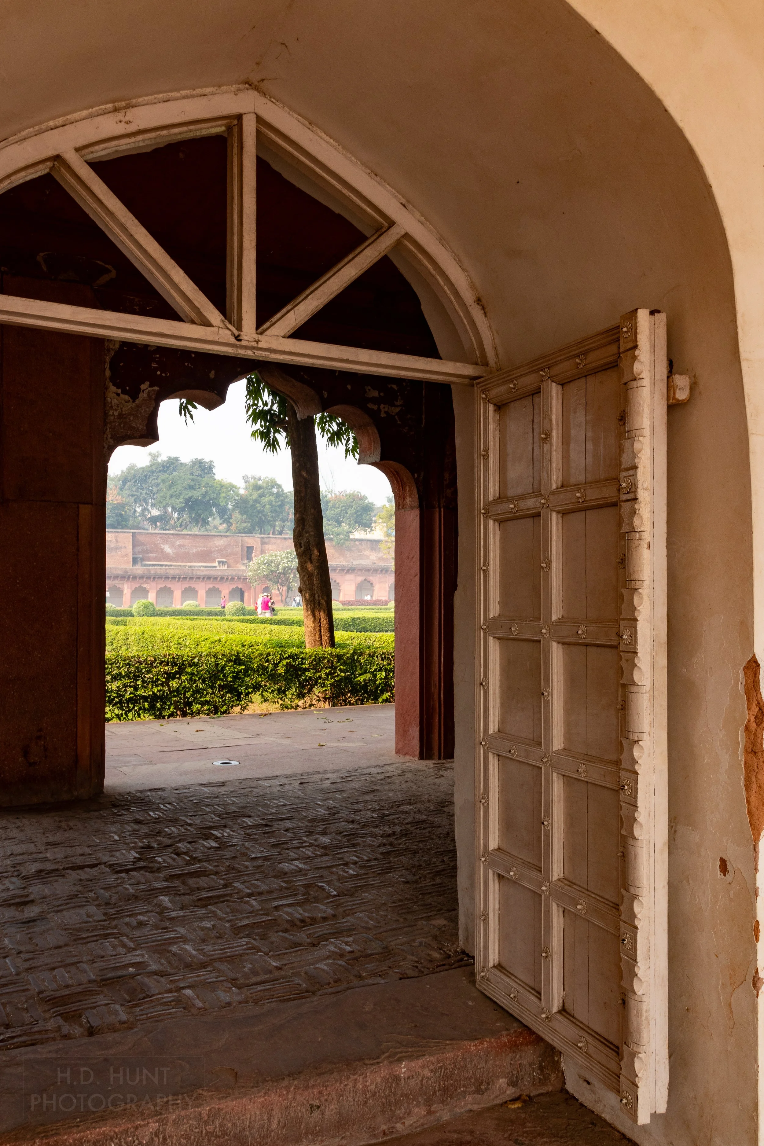 A white wooden door featuring square patterns is seen at Agra Fort, Agra, India.