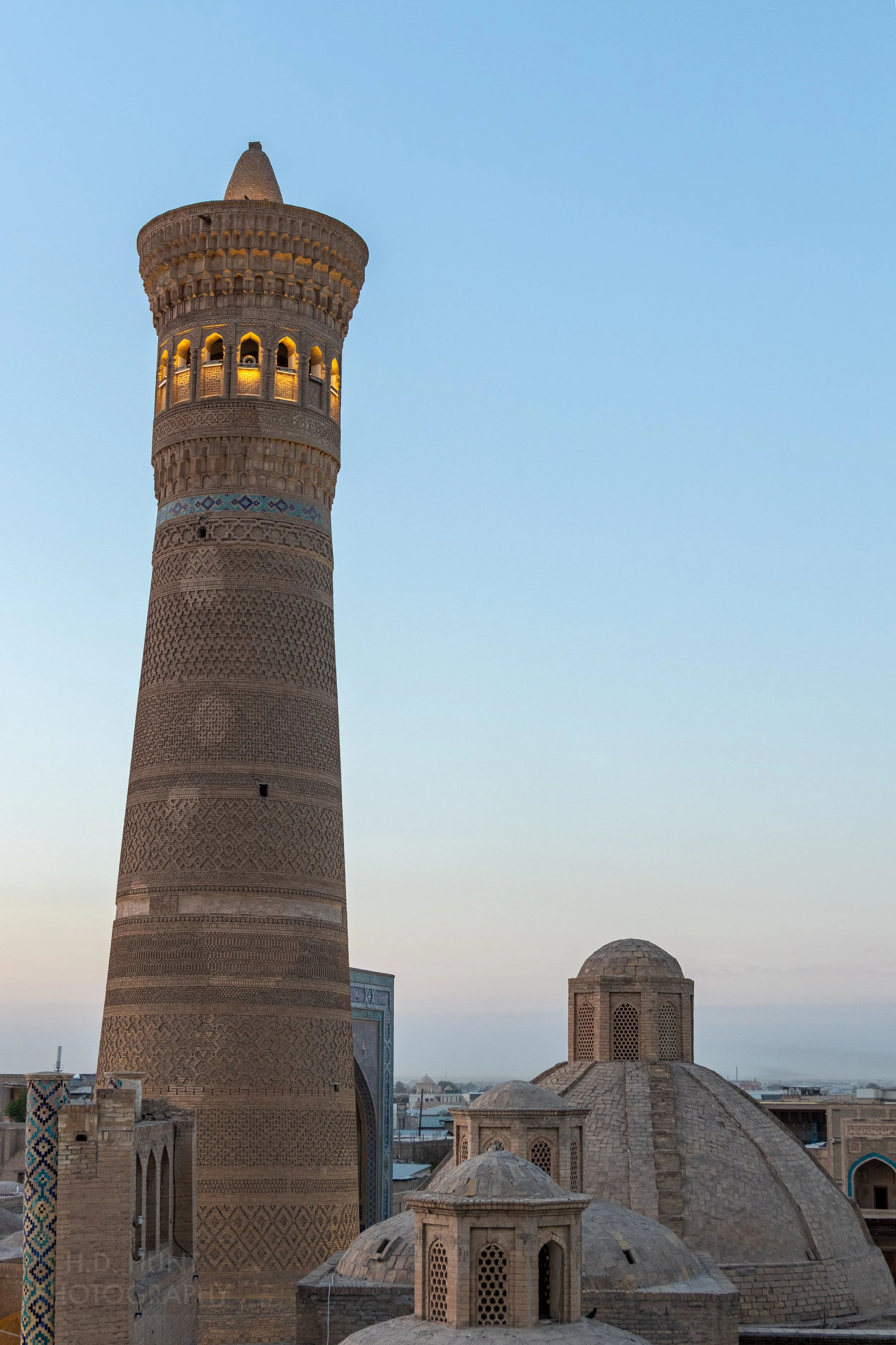 The sun sets upon the Kalan Minaret, Bukhara, Uzbekistan.