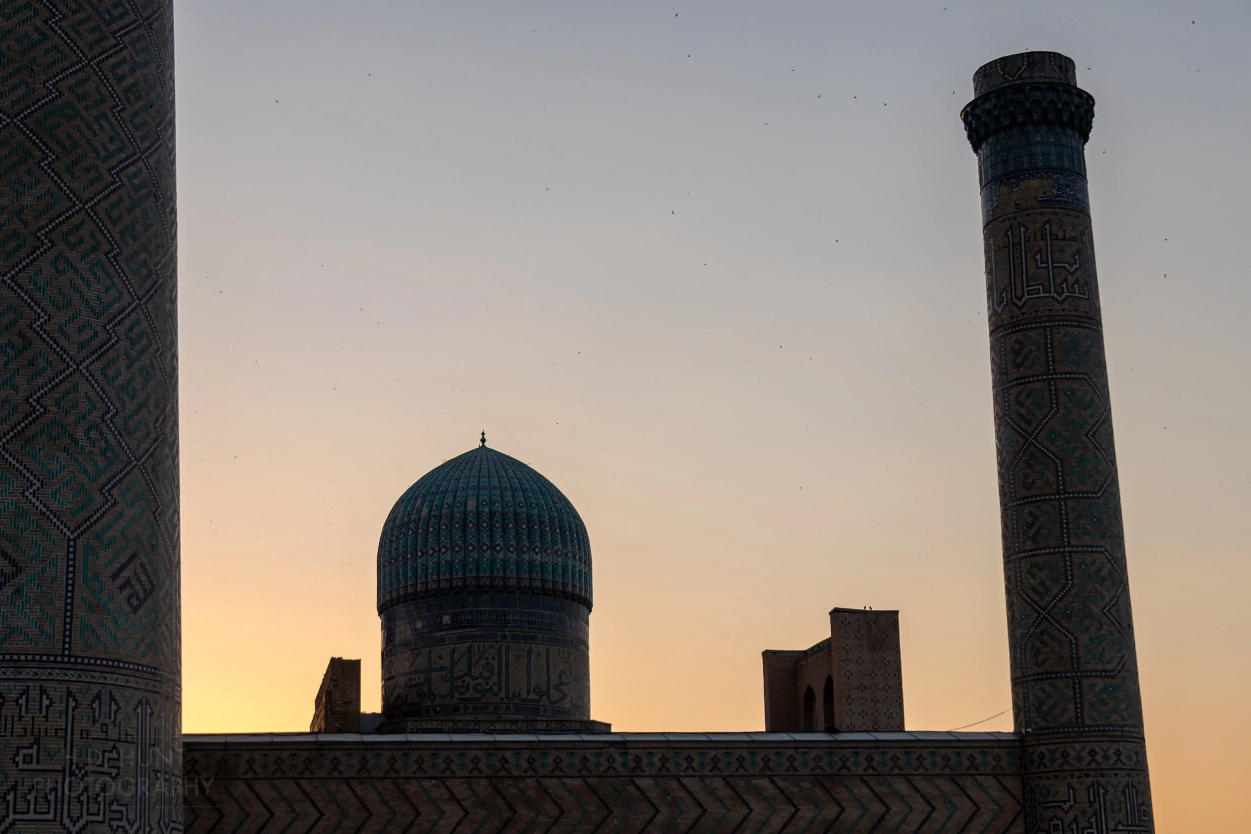 The sun sets behind the Bibi-Khanym Mosque, Samarkand, Uzbekistan.