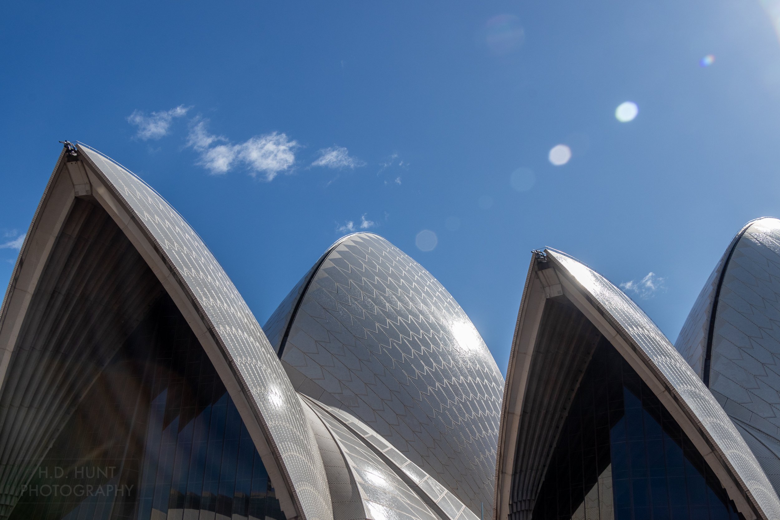 Several roof panes of the Sydney Opera House glisten in the sun, Sydney, New South Wales, Australia.