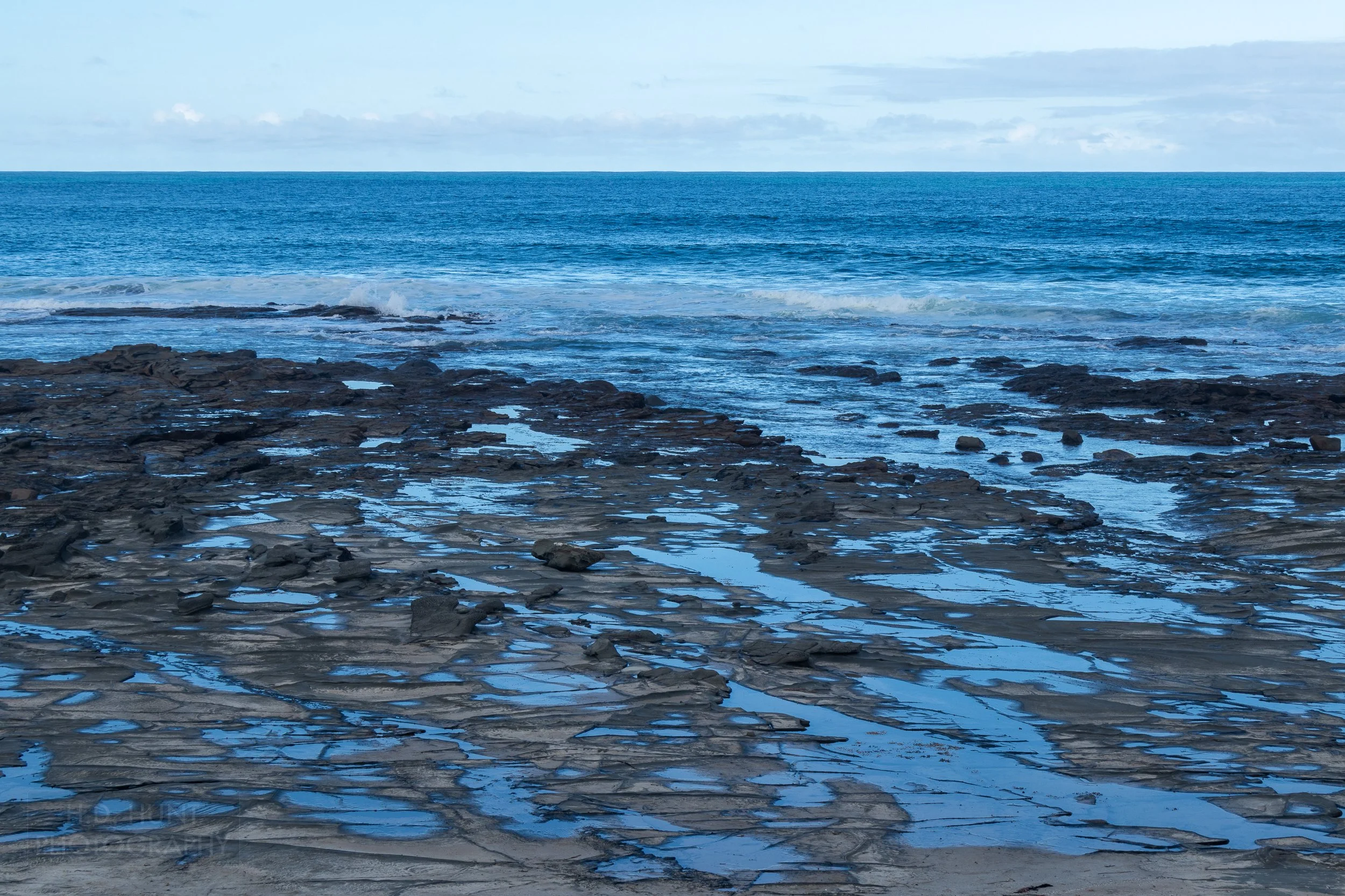 Little pools of water form on rocks along the Bass Strait, The Great Ocean Walk, Victoria, Australia.