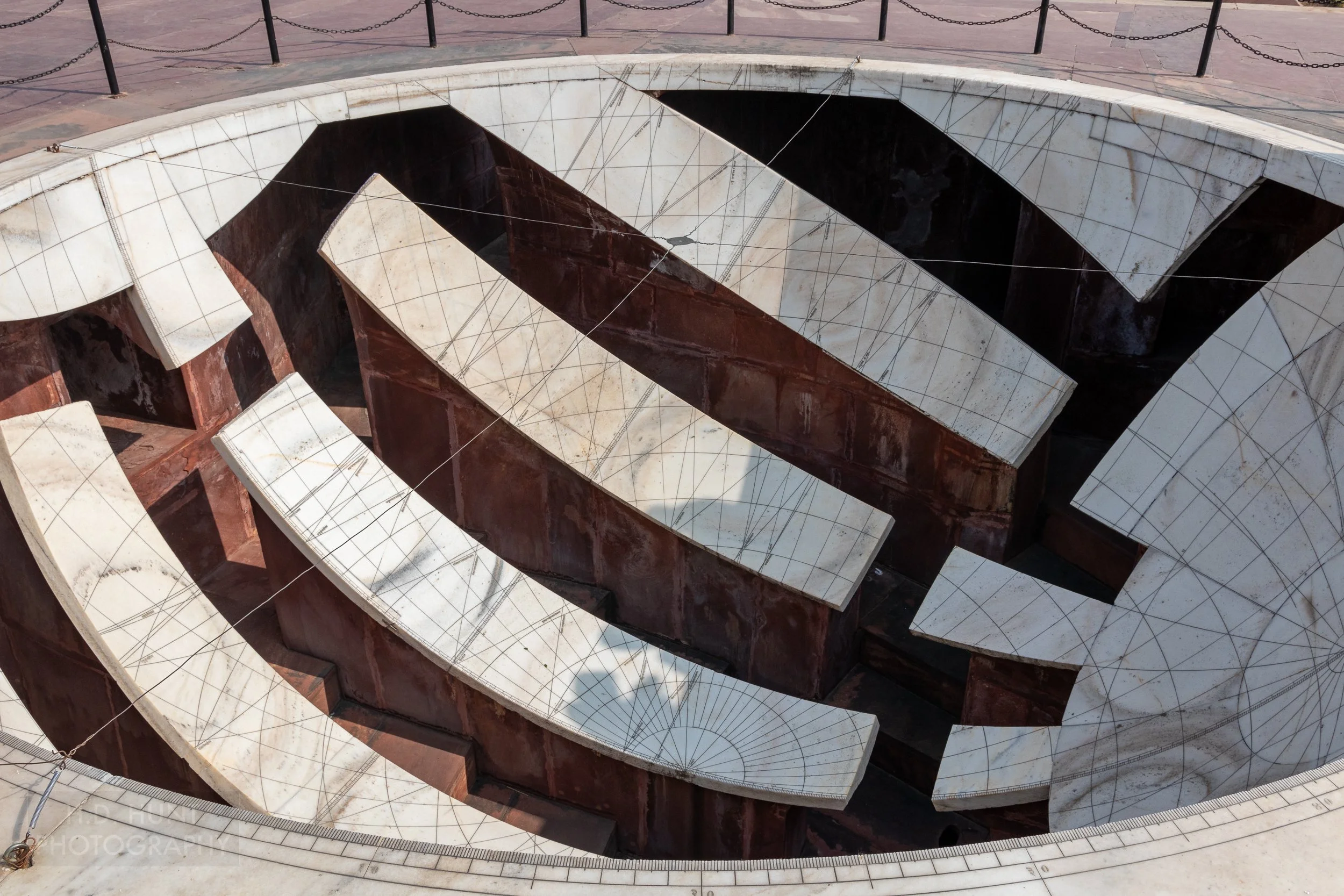 A white sphere with black markings is set into the ground at Jantar Mantar, Jaipur, India.