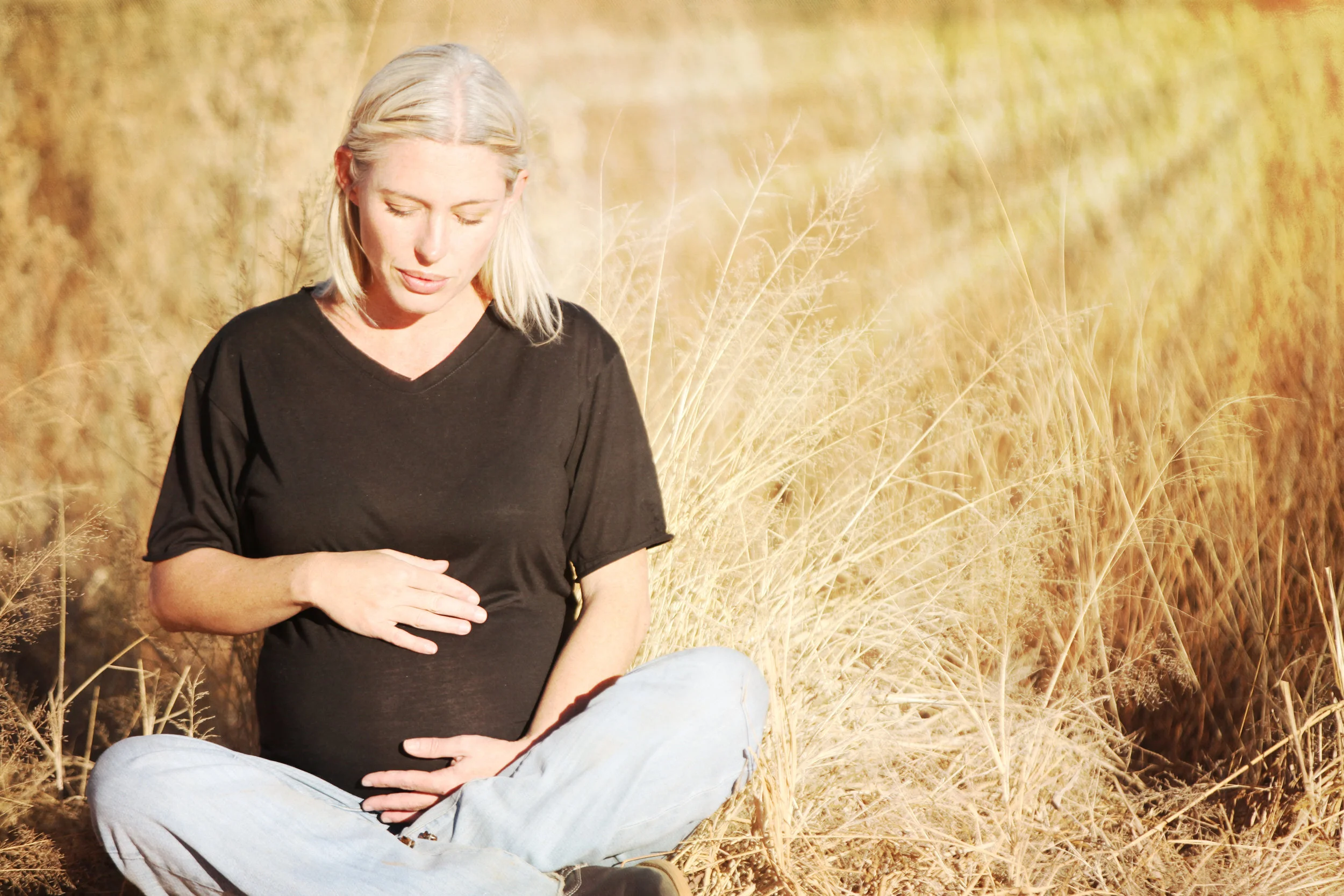Canva - Pregnant Woman Sitting on Brown Plant Field.jpg