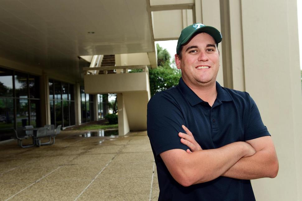 CHERYL GERBER University of New Orleans senior Timothy Juhas, 31, stands on the school's campus after finishing his morning classes. Juhas will travel to his job supervising playgrounds in Jefferson Parish, La., and pick up his two daughters from school during a late-afternoon lunch break.