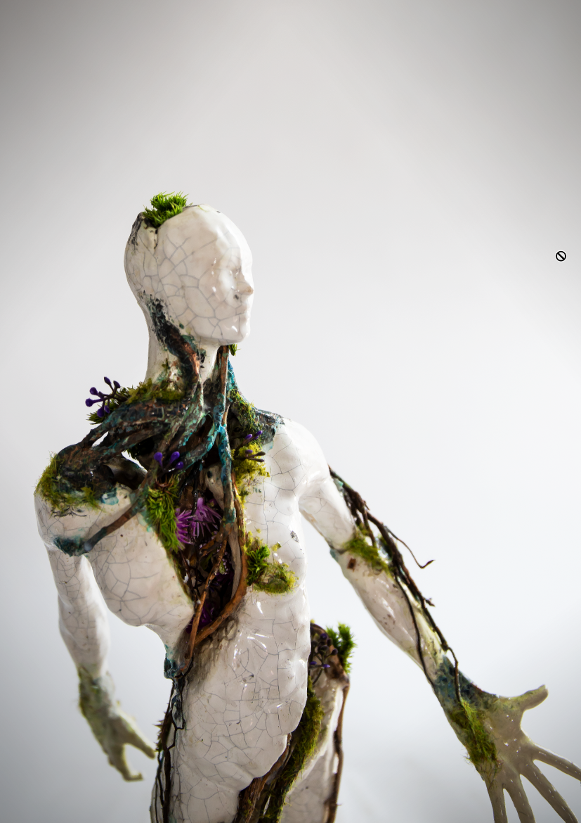 An art sculpture of a humanoid figure with a cracked white exterior, intertwined with twigs and moss, with small purple flowers, resembling a blend of human and nature.
