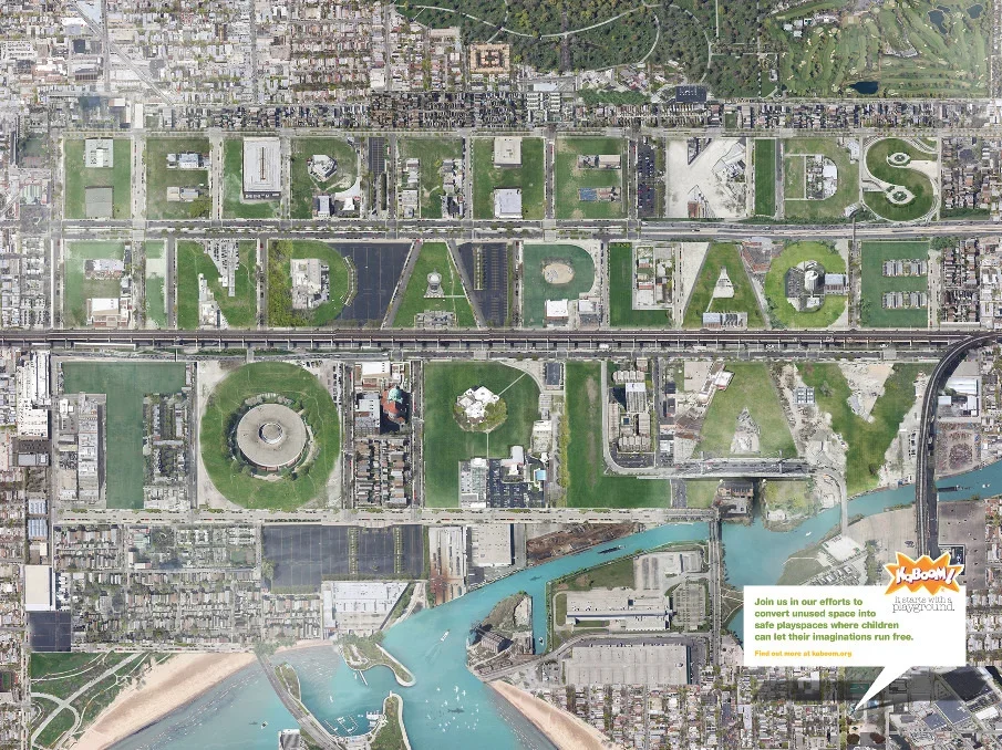 Aerial view of Downtown Orlando, Florida, with large green spaces spelling out "ORLANDO" and "VEY" across the city, along with surrounding buildings, a river, and a beach area at the bottom.