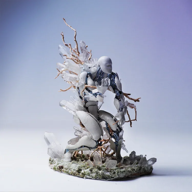 A sculpture of a person with a baseball cap, made from various materials including glass, metal, and branches, in a crouching pose.