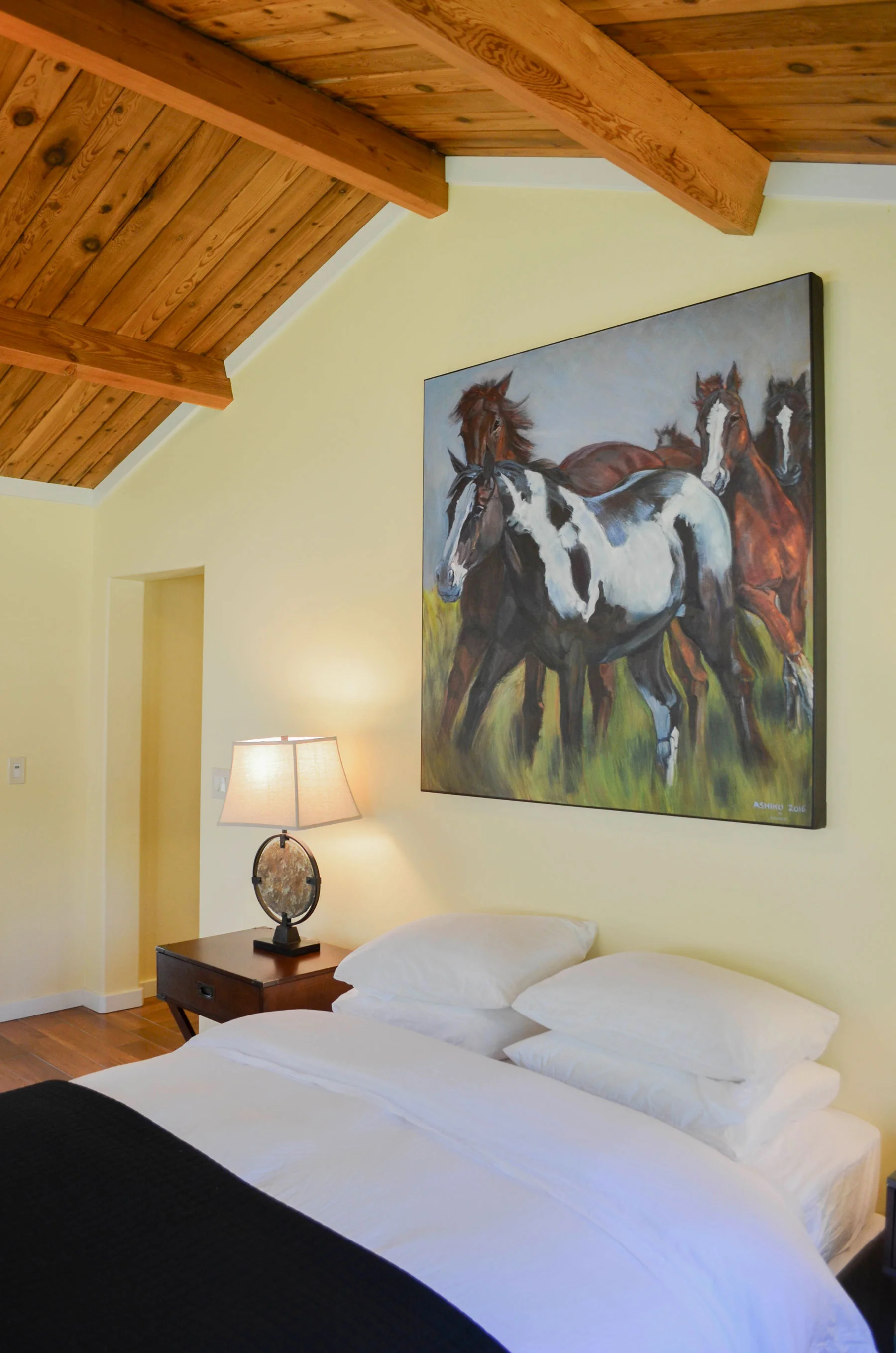 Room 15 has a comfy queen bed with clean, eclectic furnishing and lovely natural light.