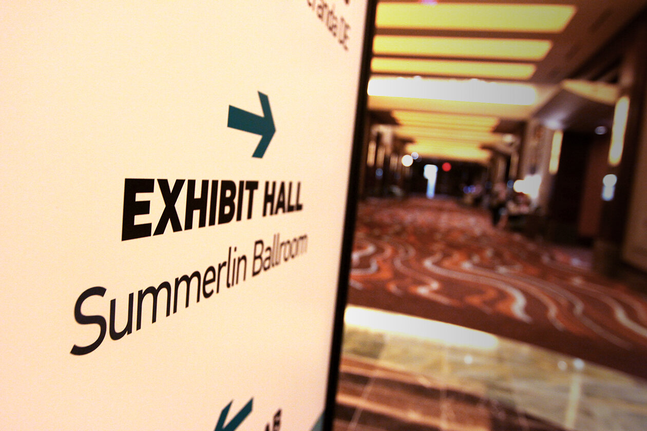   THIS IS THE WAY:  A close up of the central directional sign pointing down one of the conference hallways 