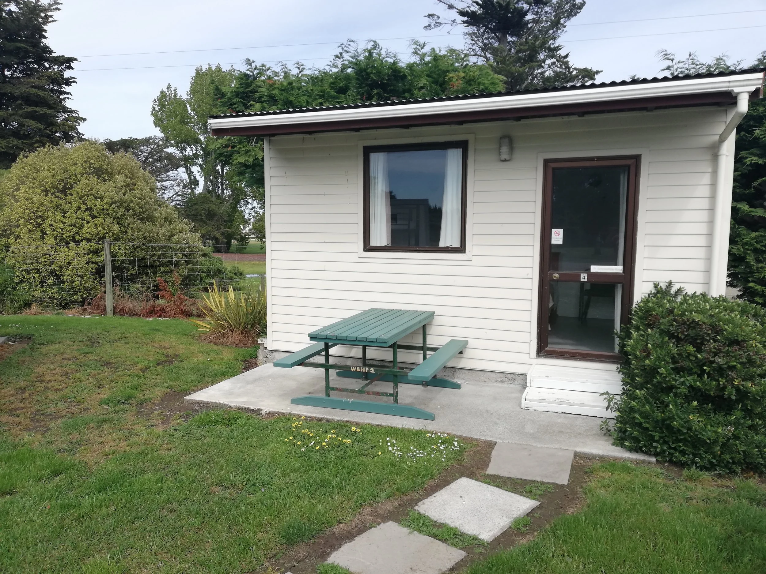 A small cabin with a fully made queen size bed and a set of bunks with the same facilities as our large cabin excluding a sink with running water.