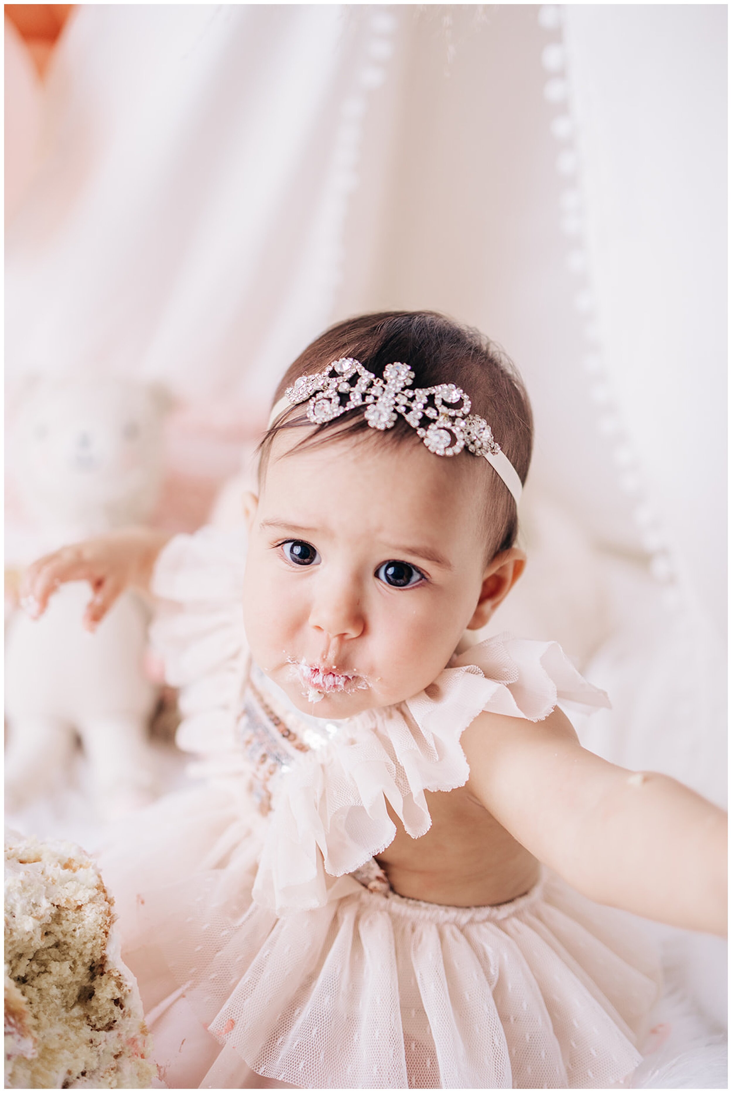 girl smiling during cake smash