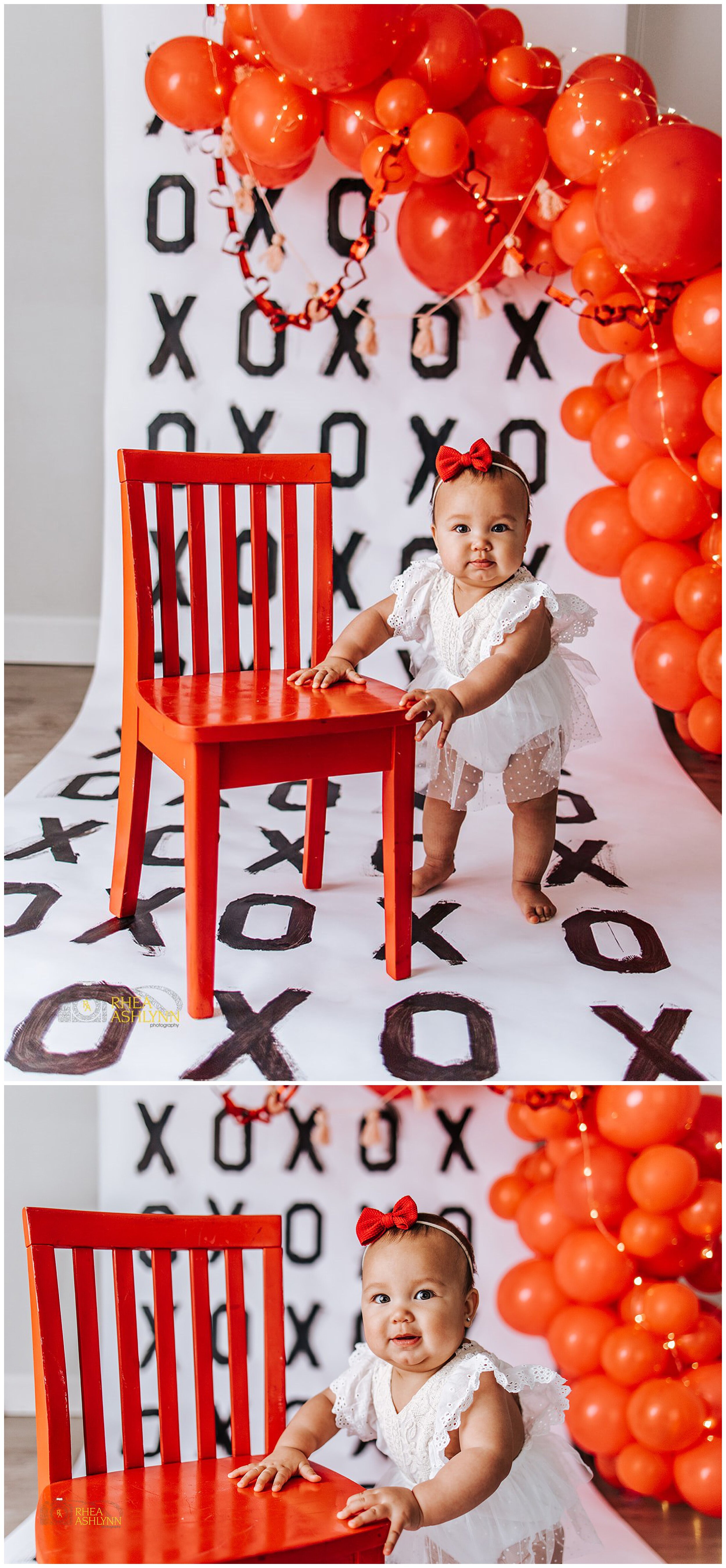 toddler holding onto red chair for photoshoot