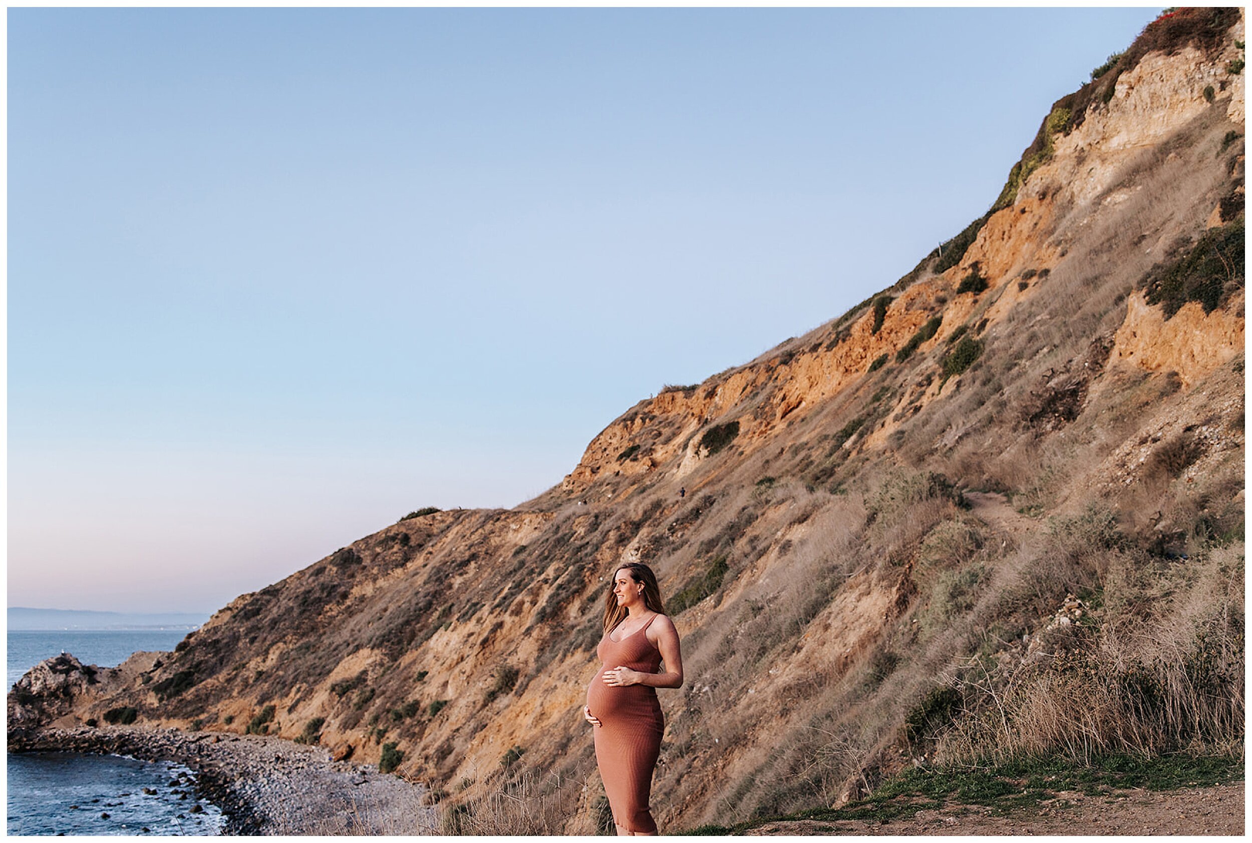 pregnant woman standing on mountain