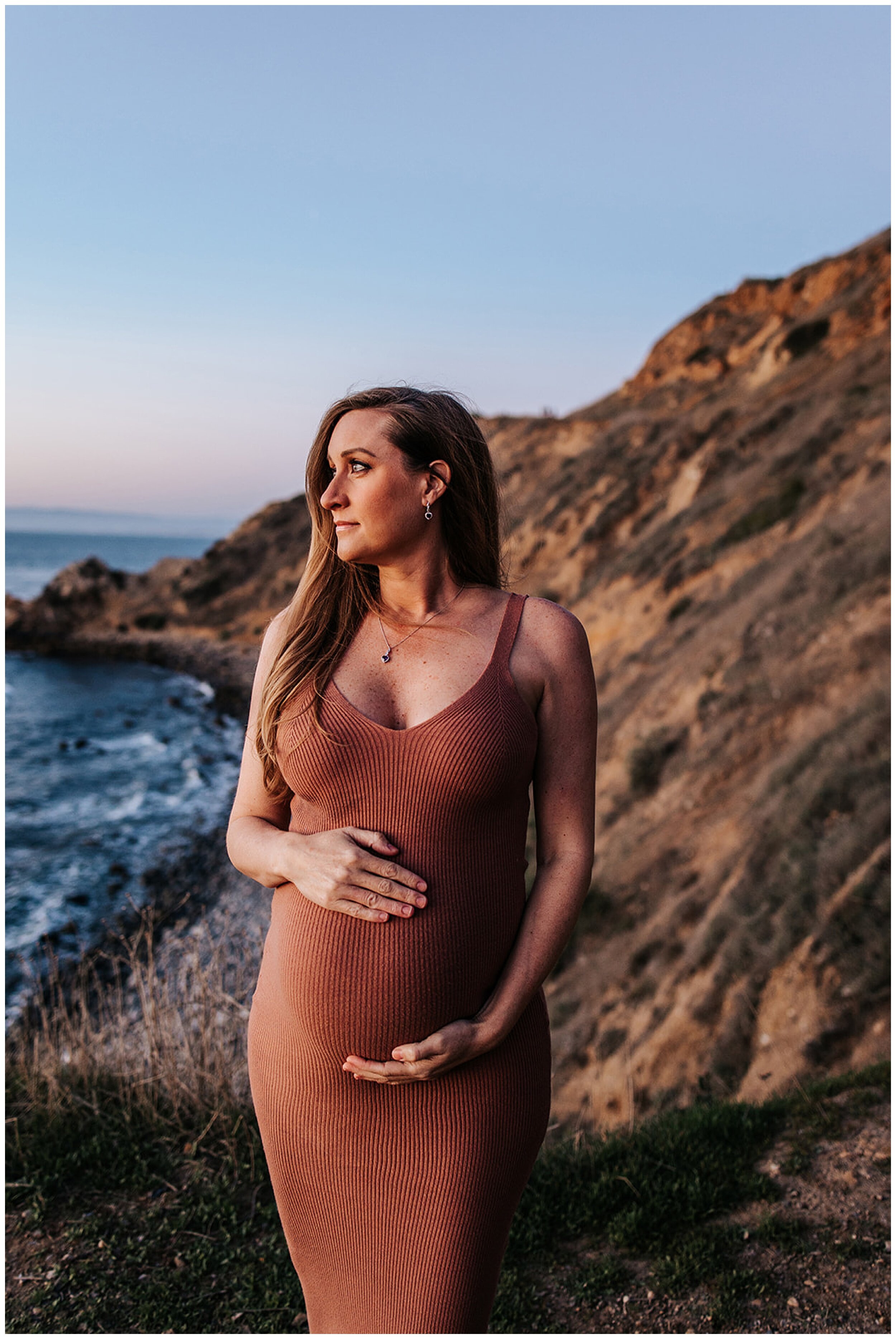 pregnant woman looking out into ocean