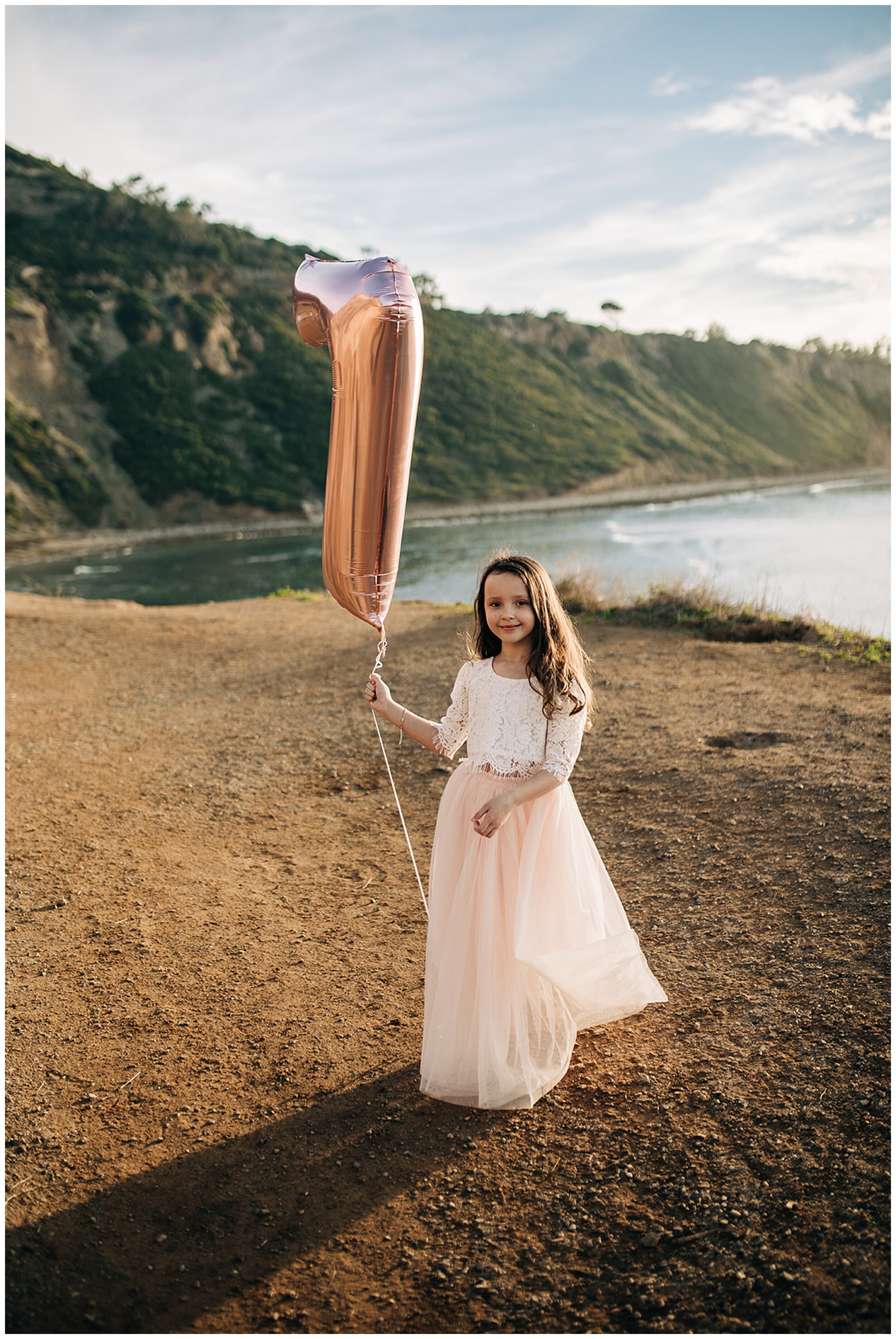 girl holding 7th birthday balloon