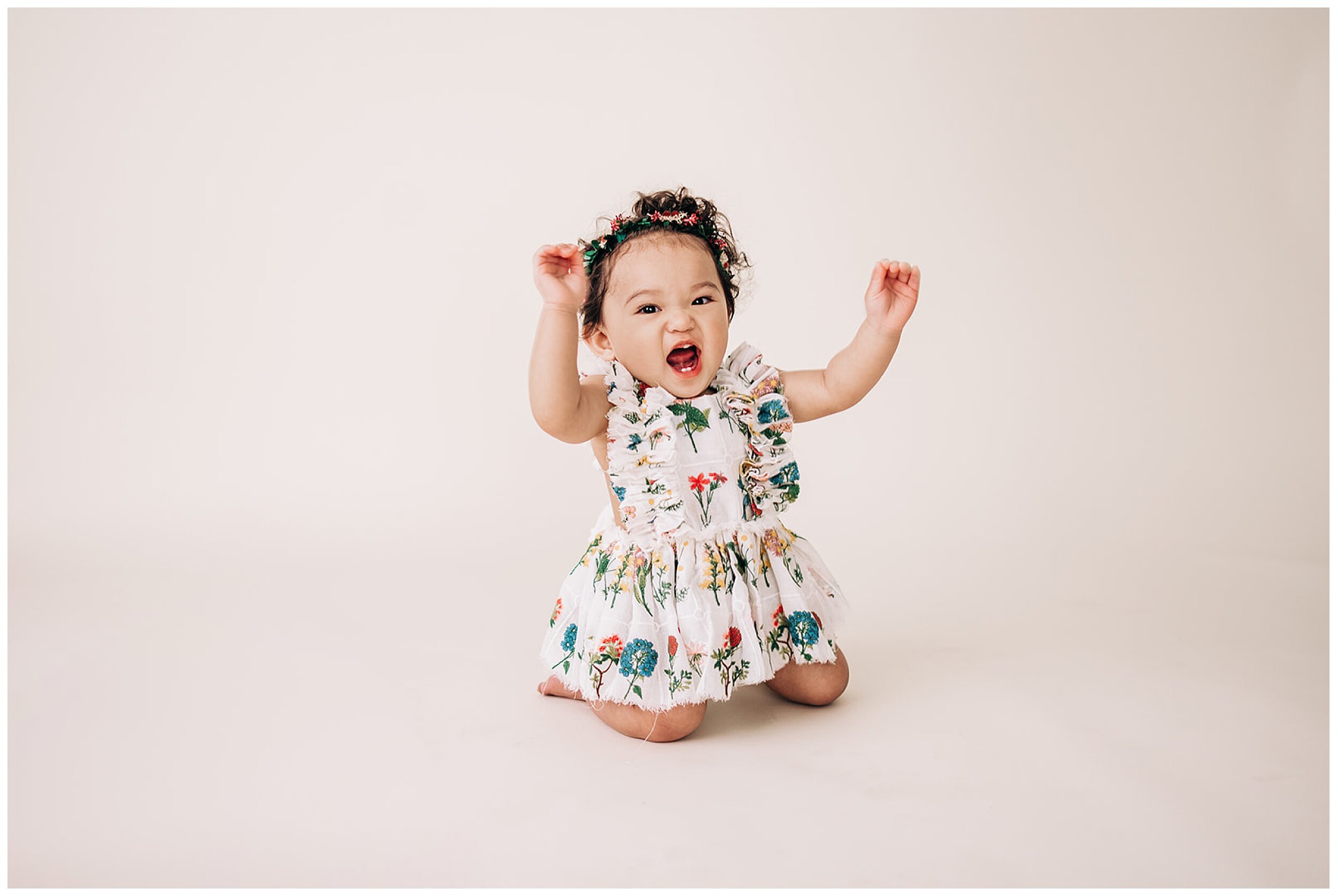 young girl smiling with arms up