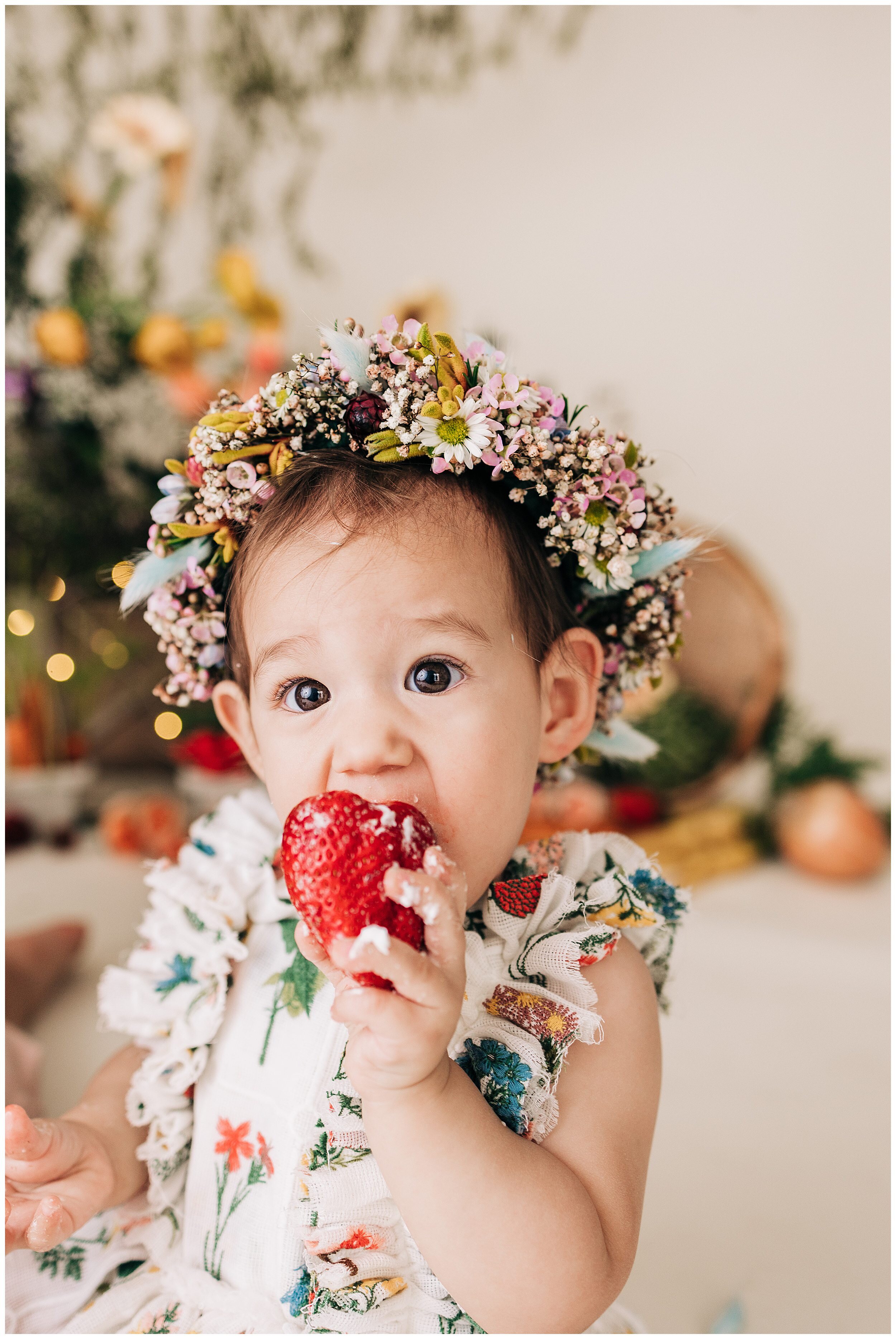 young girl eating strawberry