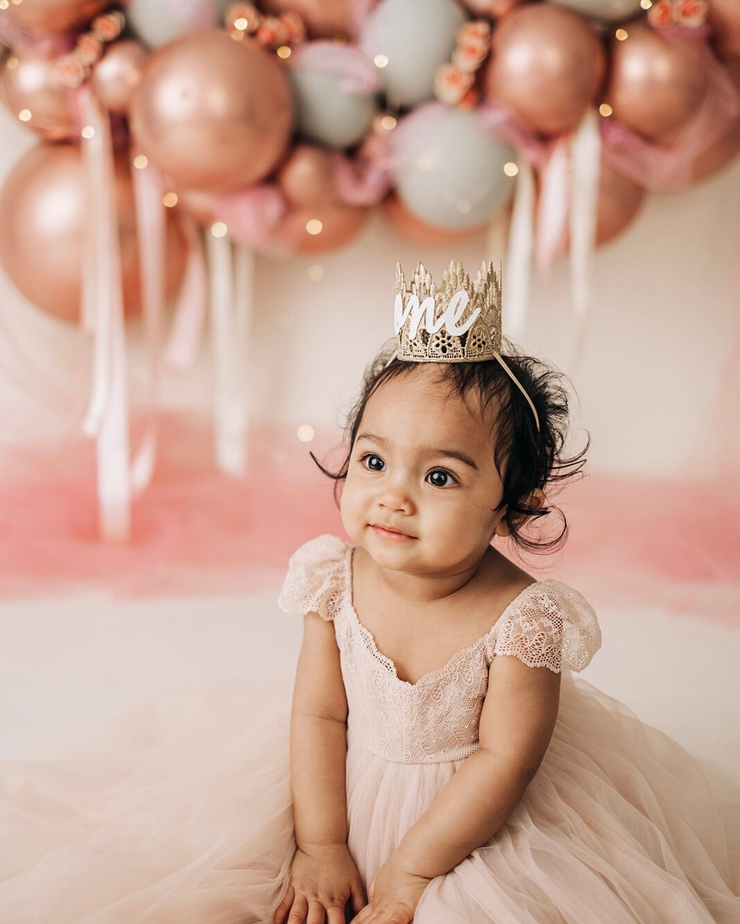 This little girl was sweet as can be 💗​​​​​​​​
​​​​​​​​
For her cake smash, we chose a girly color scheme with rose golds, pinks and added little pink roses and twinkle lights throughout the balloon arch. To top it all off, her cake matched perfectl