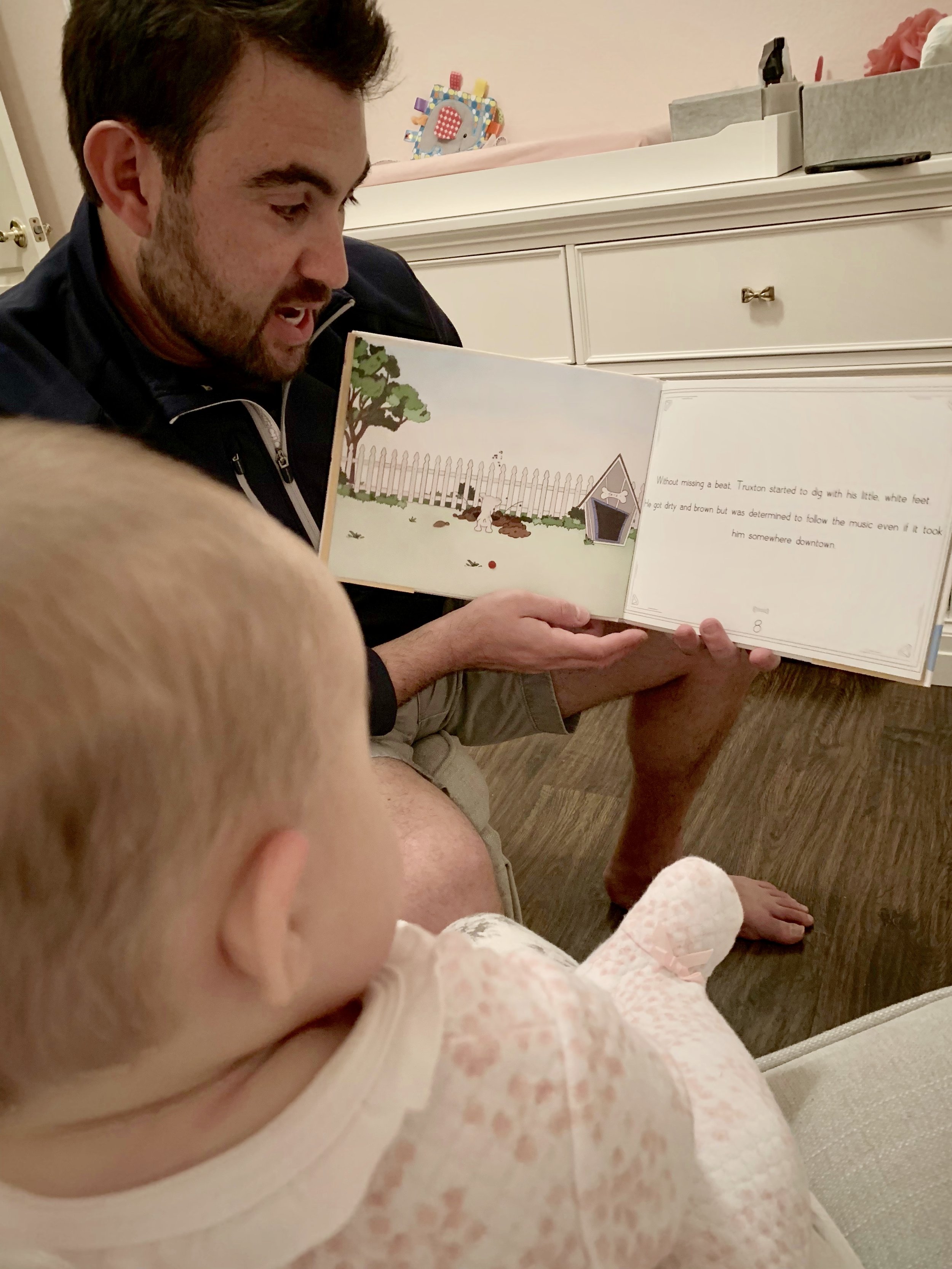 Dad reads Jazzland to new baby