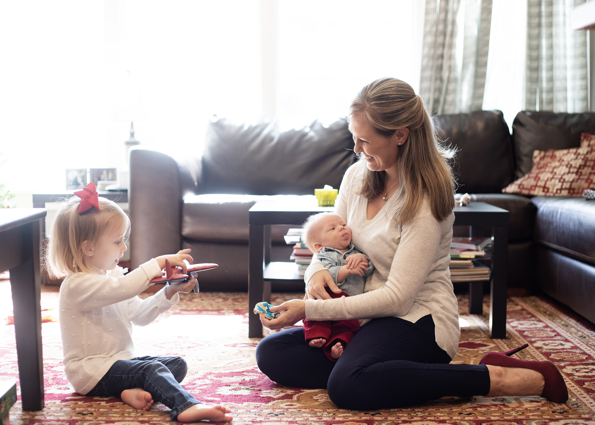 home newborn photography mom playing with sister