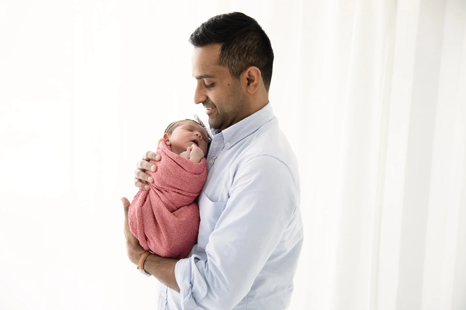 houston newborn photography father holding baby girl